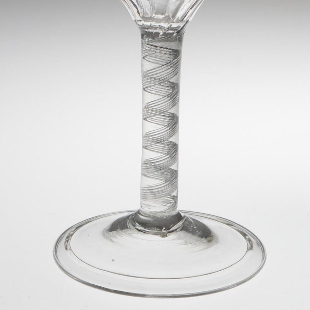 Heading : Rib moulded air twist stem Georgian wine glass
Period : George II - c1745
Origin : England
Colour : Clear
Bowl : Round funnel with rib moulding
Stem : A 7-ply air twist band
Foot : Folded conical
Pontil : Snapped
Glass Type : Lead
Size : 