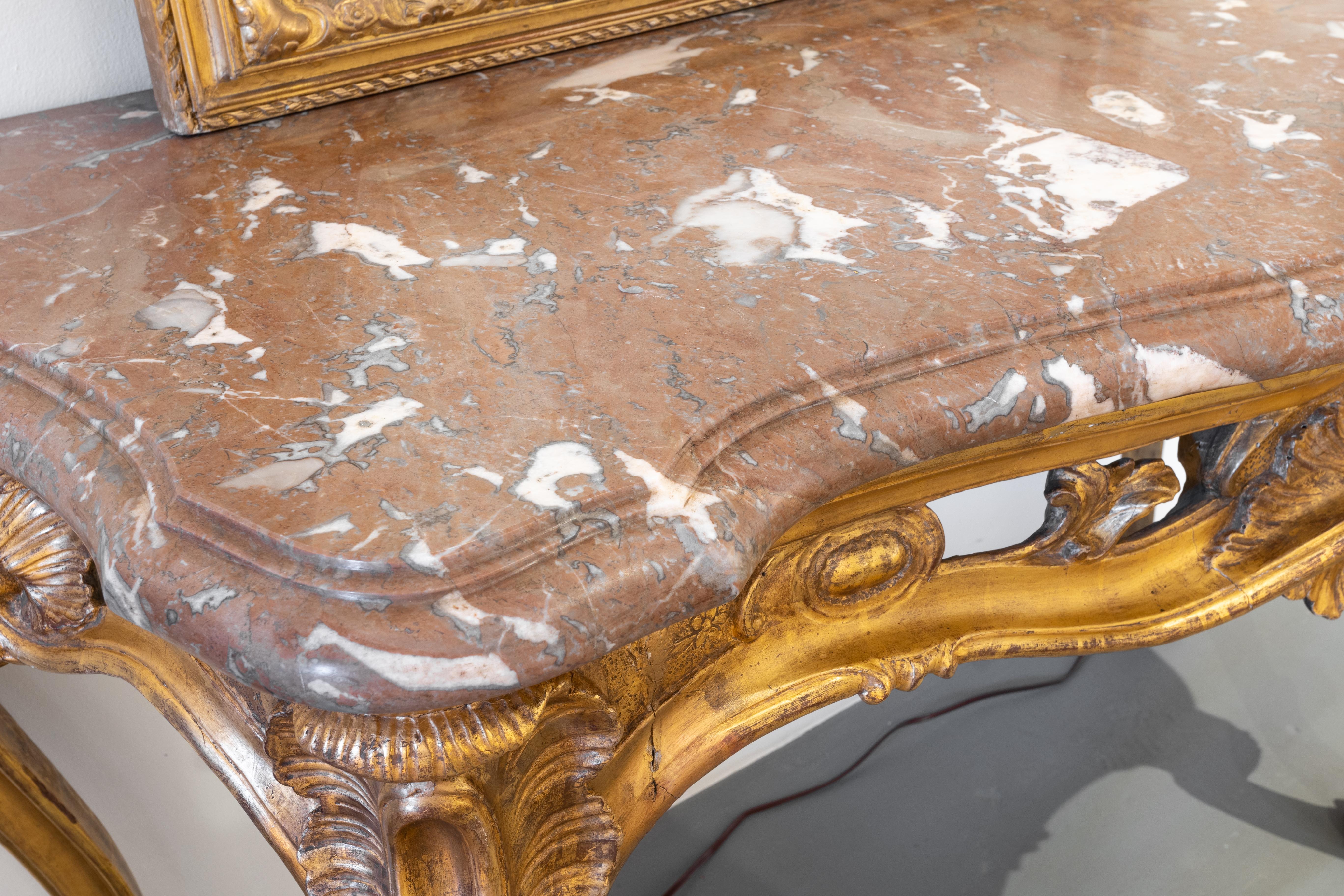 A fine Italian 18th century giltwood carved console with the original marble top.