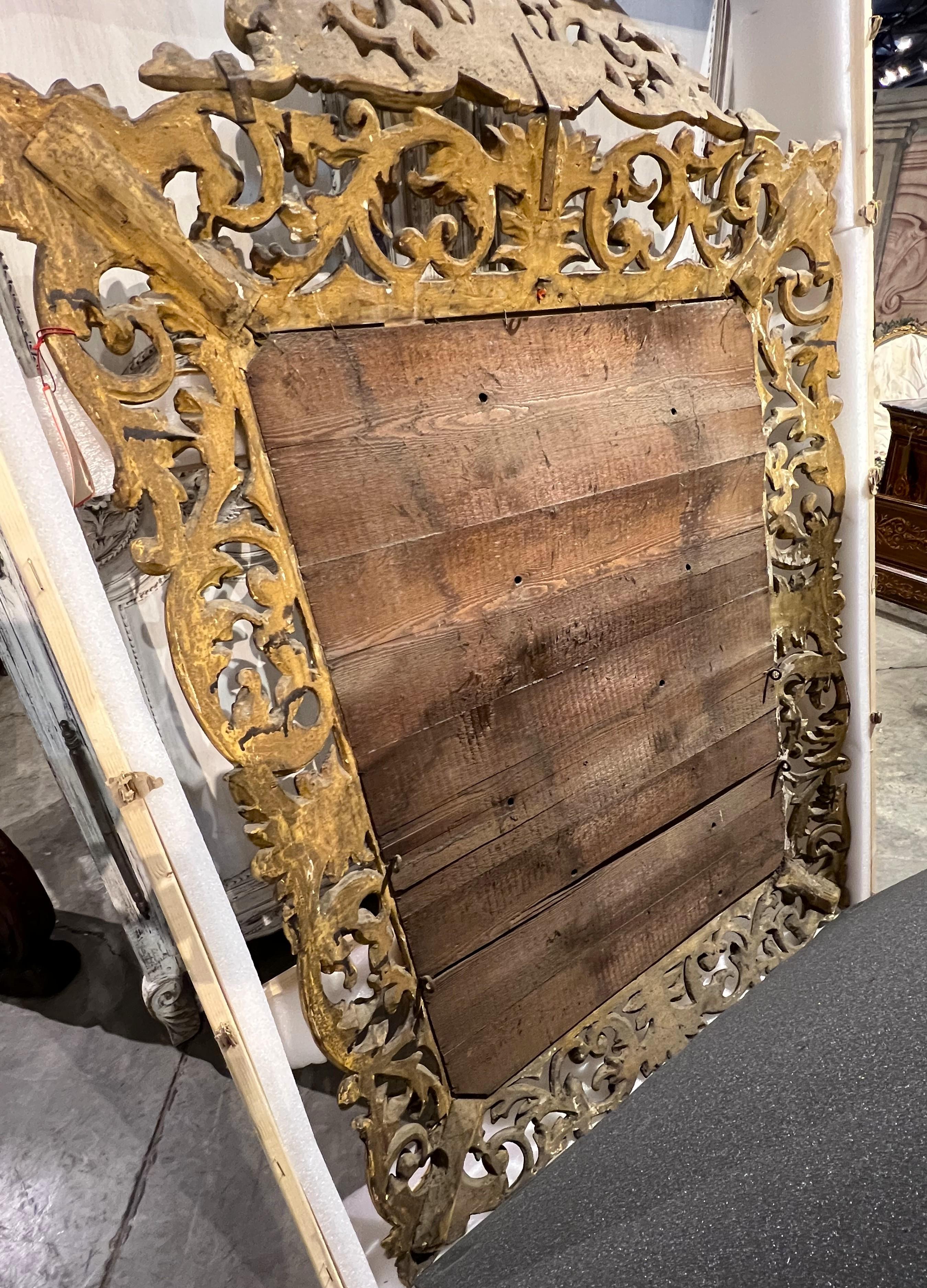 More information coming soon…

A beautiful and ornate Florentine mirror, dating to the late 1700s, features a beveled glass surrounded by a hand-carved giltwood frame.  The elaborate frame has motifs of S-scrolls, crenellation, foliate scrolls,