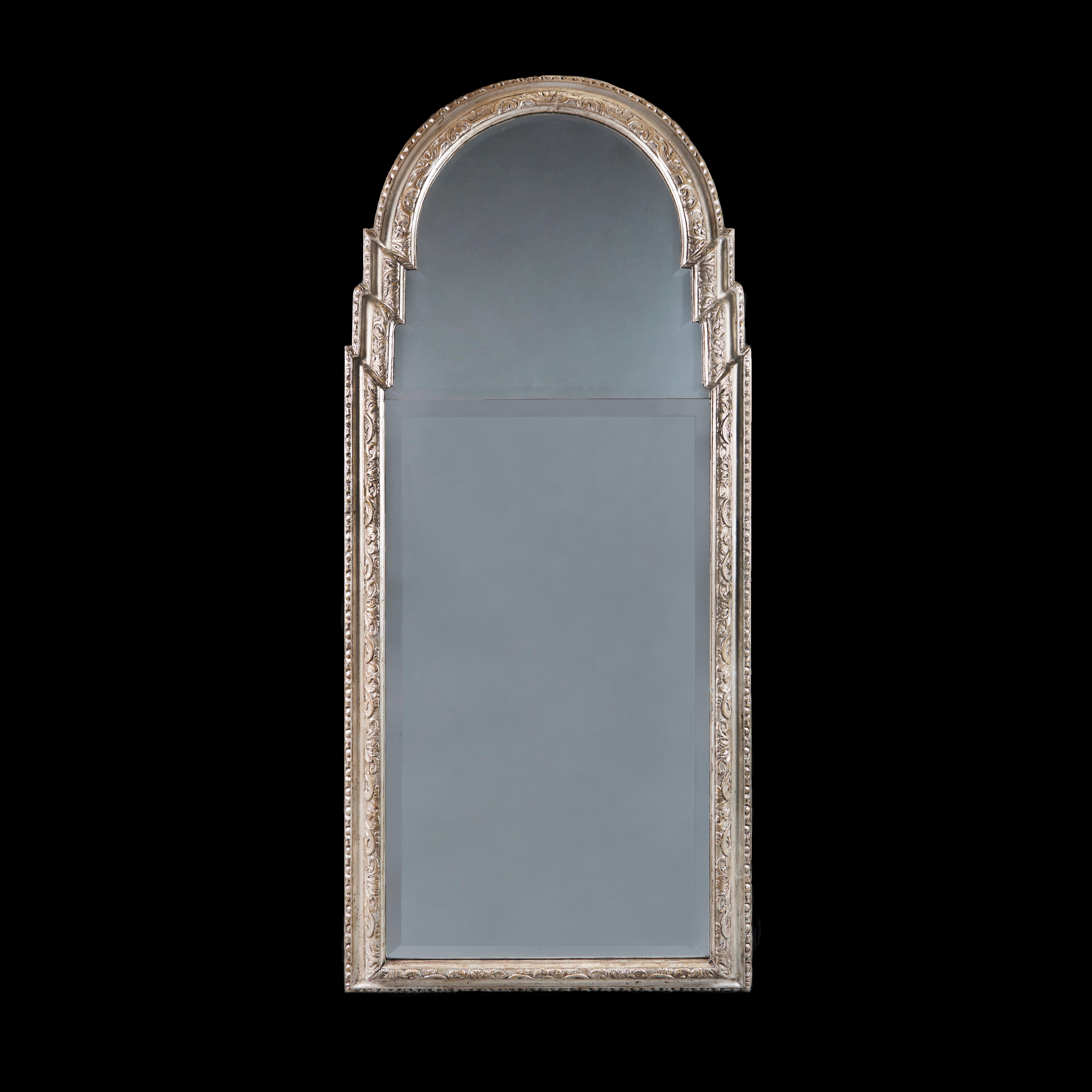 England, circa 1780

A fine late eighteenth century silver gilt pier mirror with mercury glass split splate with bevelled edges, the frame carved with foliate designs and punched decorated, egg and dart borders to the outer edge, with arched