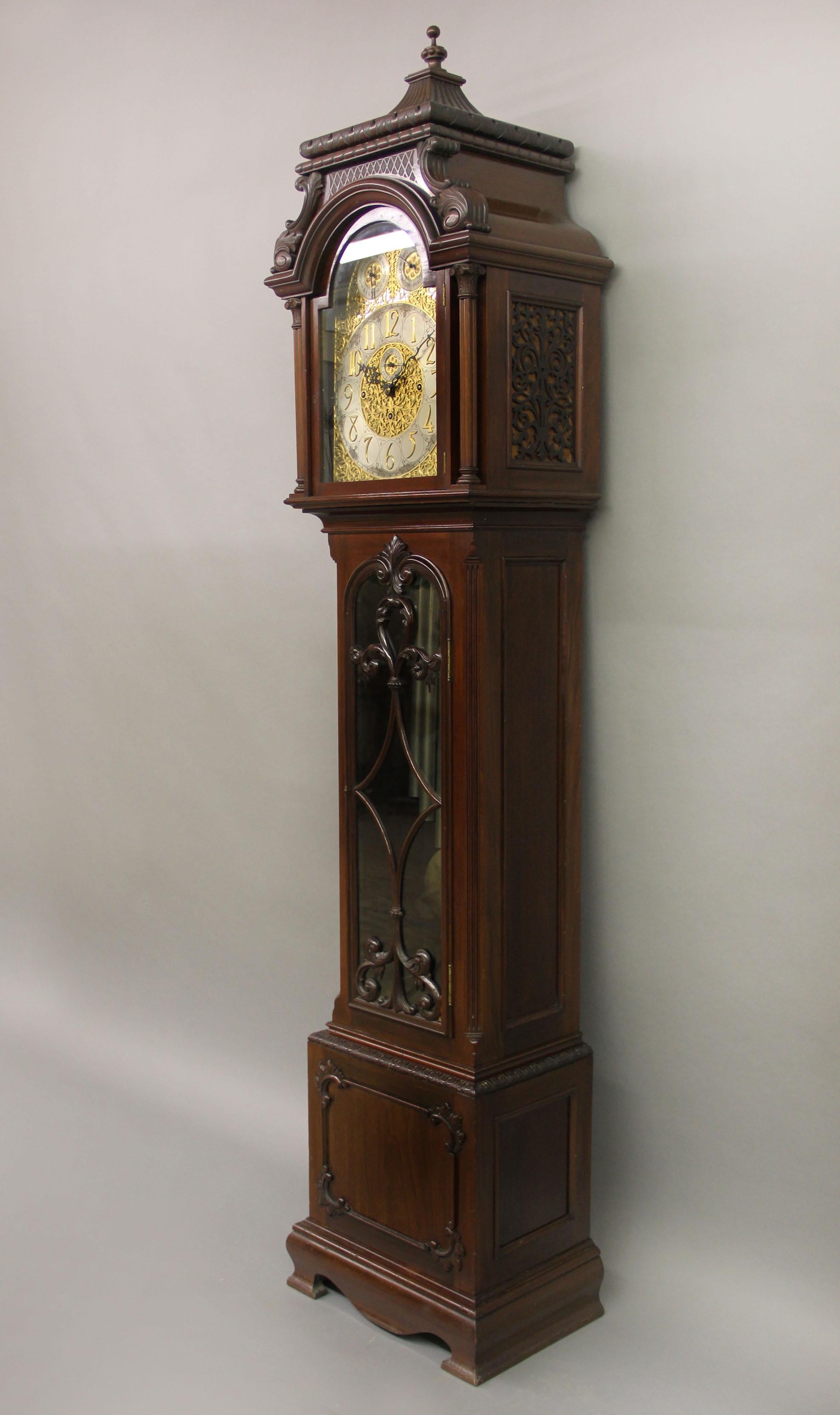 A fine late 19th century English carved nine tube longcase grandfather clock

The clock with an eight day movement and chiming on nine tubes. The very elaborate designed face with Arabic Numerals enclosing a subsidiary seconds dial in the center,