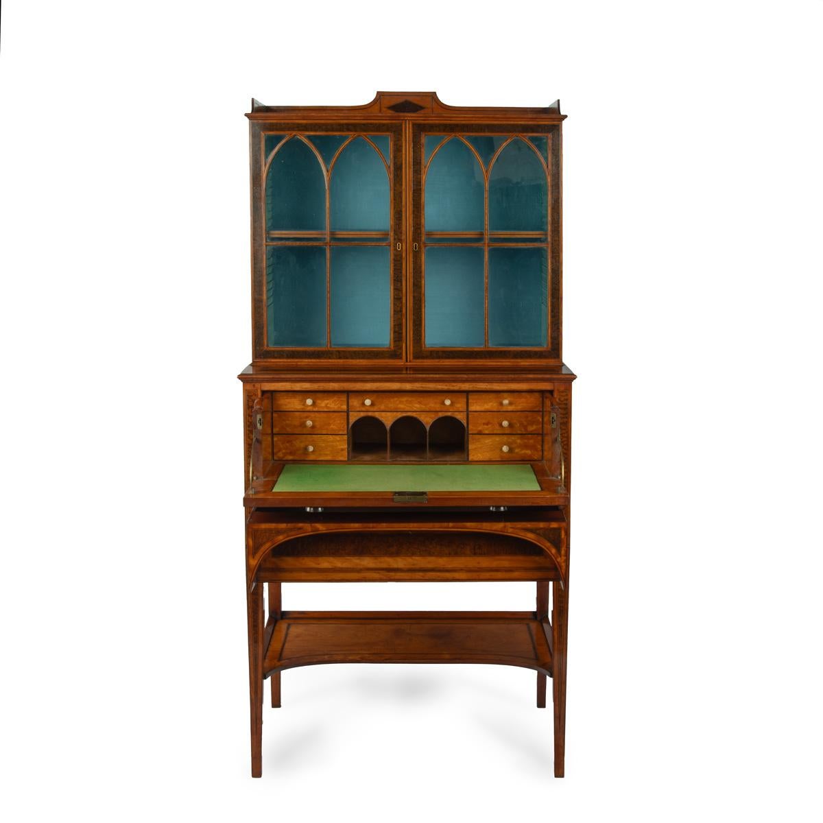 A fine late George III satinwood and snakewood secretaire cabinet, attributed to George Simson of London, of rectangular form, the upper section with a pair of glazed doors with fine gothic astragal glazing bars enclosing a single shelf, above a