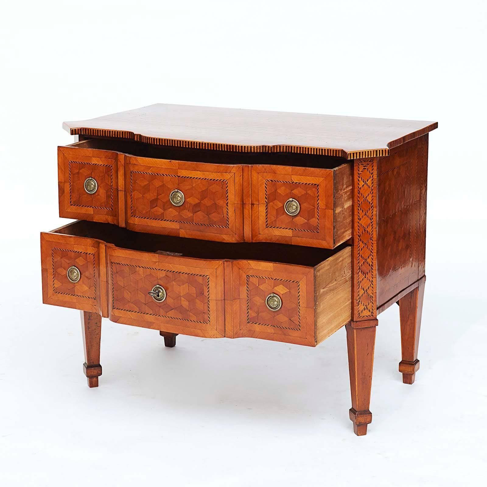 A fine Louis XVI walnut, ebonized and fruitwood parquetry commode, circa 1780, the rectangular top with canted fore-corners and a stepped front, above two stepped long drawers, raised on canted square tapered legs.

   