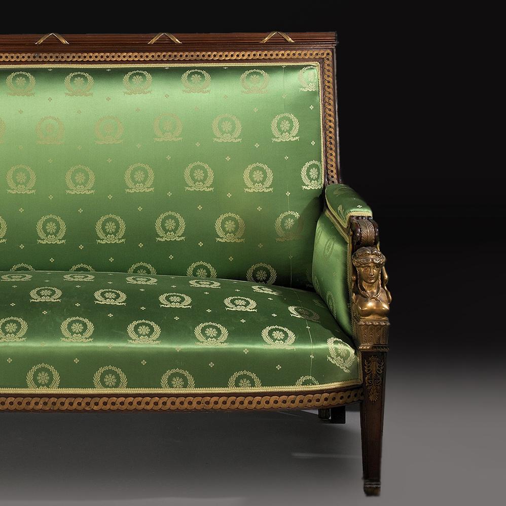 Canapé en acajou et bronze doré du Second Empire à la manière de Jacob-Desmalter,  avec des accoudoirs surmontés d'hermès de cariatides finement moulés.     

Français, Circa 1880.