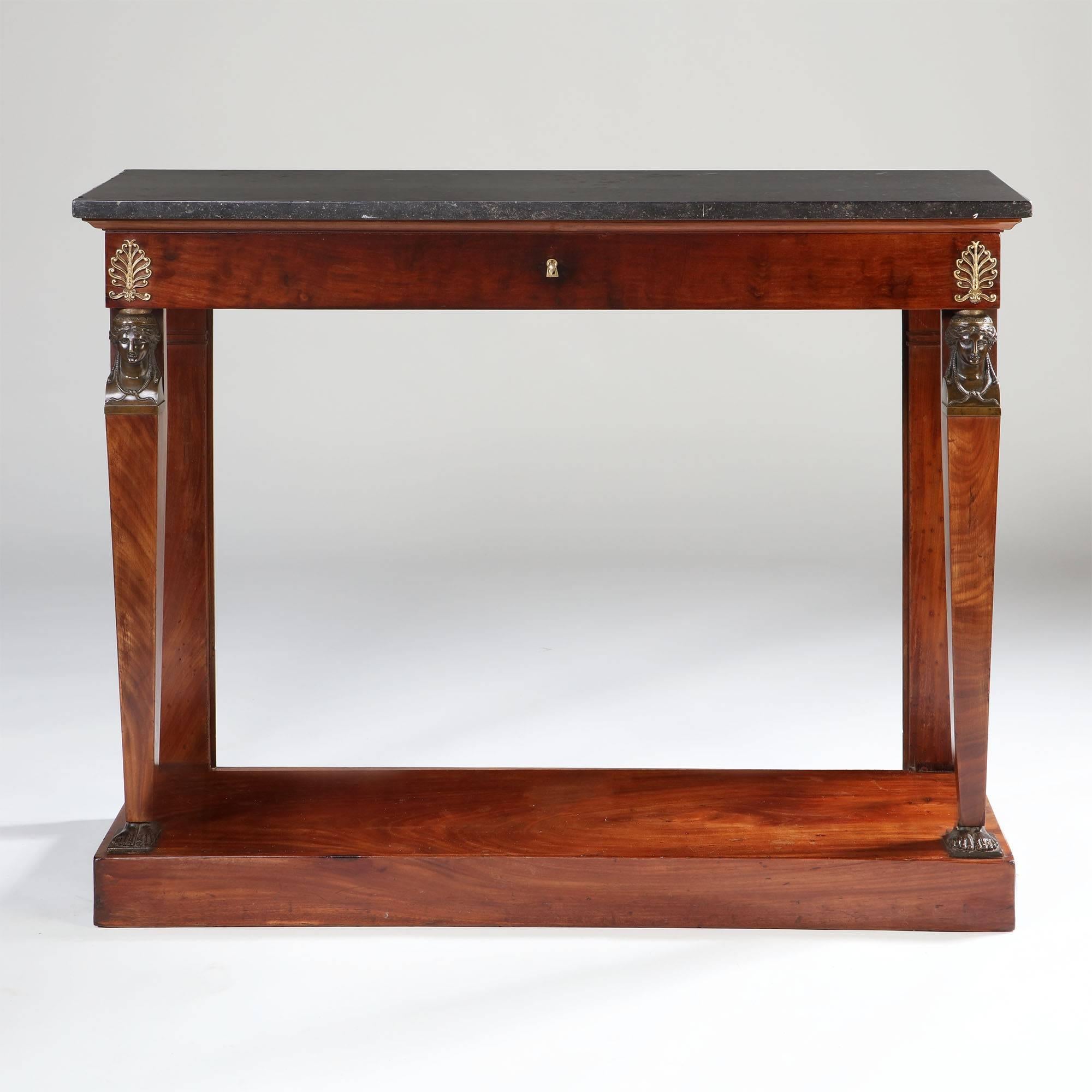 A fine mahogany Empire console table, with a single drawer to the frieze, original marble top, and bronze caryatids to the uprights.