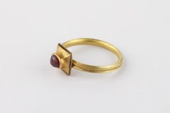 A Fine Medieval Finger-Ring set with a Cabochon Garnet