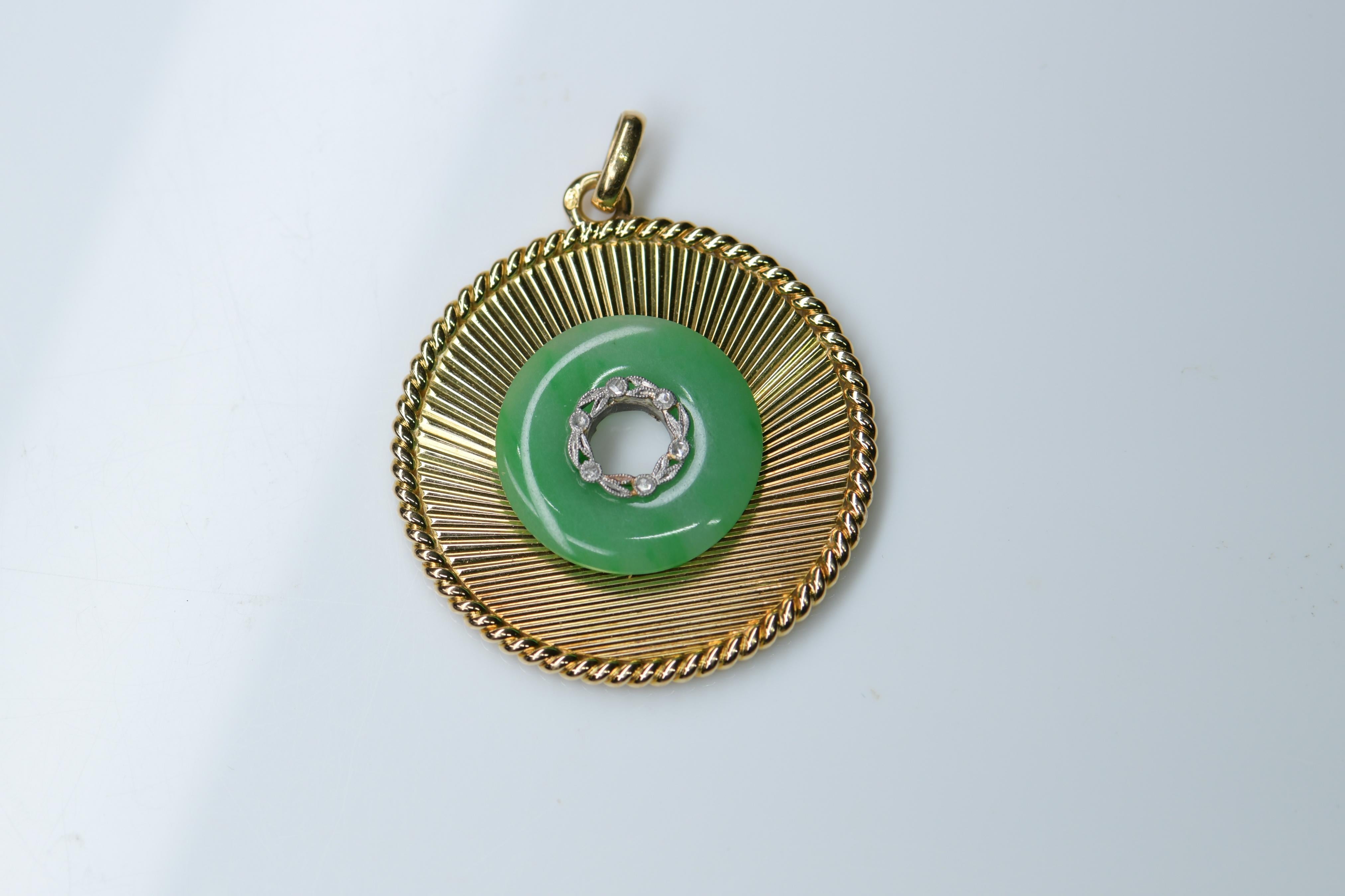 This is a very fine piece from Mellerio Paris in 1950. It used an excellent quality natural, untreated jadeite disc.  It is a unique fine pendant that you shouldn’t let it go.

STONES
Jadeite: 19mm in diameter  
Old Cut Diamonds: