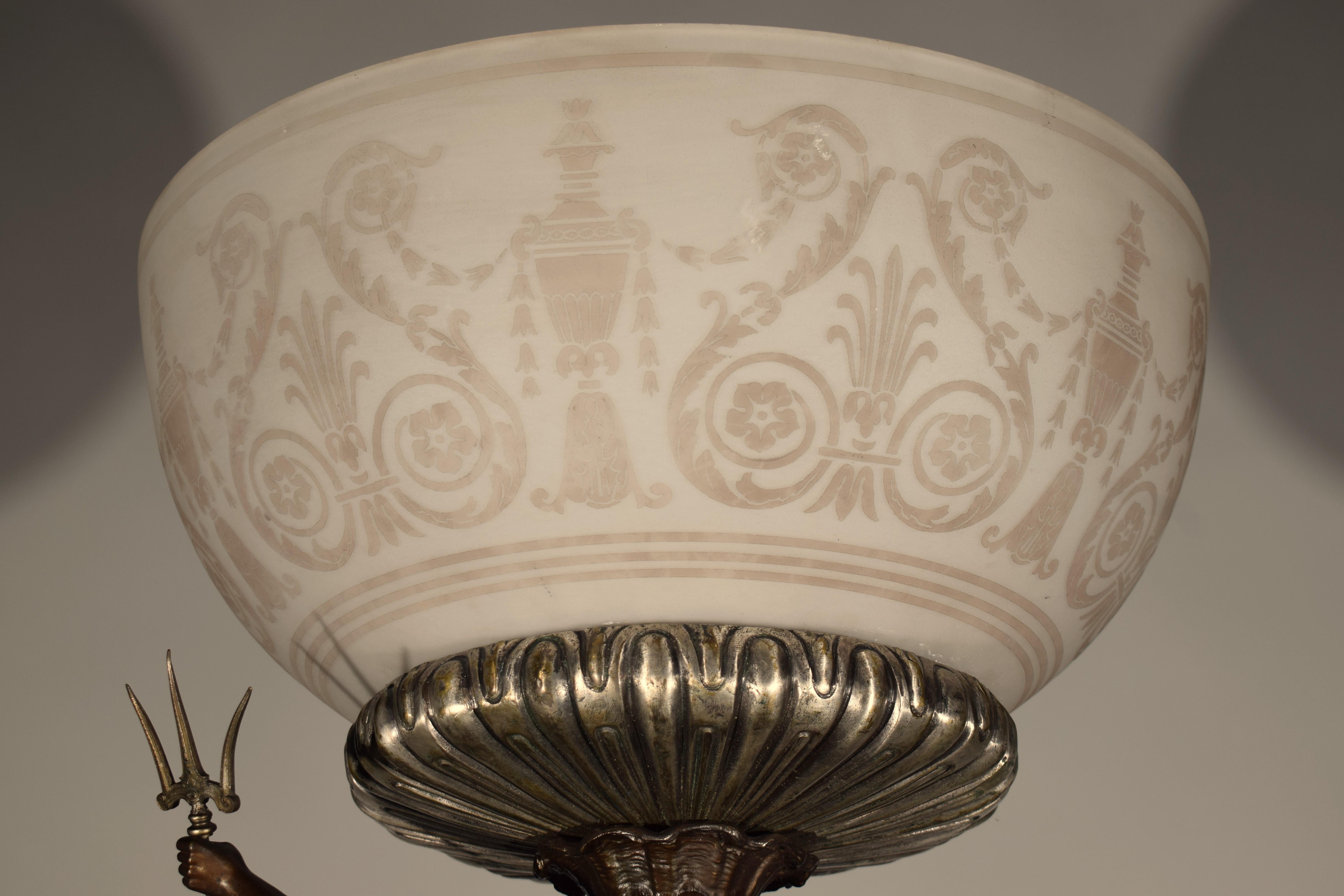 A Fine Metal & Acid Etched Glass Centerpiece. The ebonized wooden plinth on which the three legged centerpiece raises. Featuring three mythological figures, Neptune, Vulcan etc. Also stylized dolphins - the shade with acid etched neoclassical