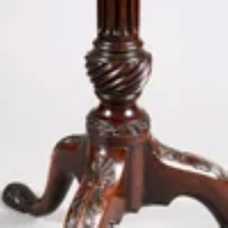 A fine mid-18th Century pie crust tripod table, the dished top with a raised and scalloped border with carved and scalloped gadrooned detail, the whole raised on a fluted column base and standing on fine cabriole legs with carved knees and feet