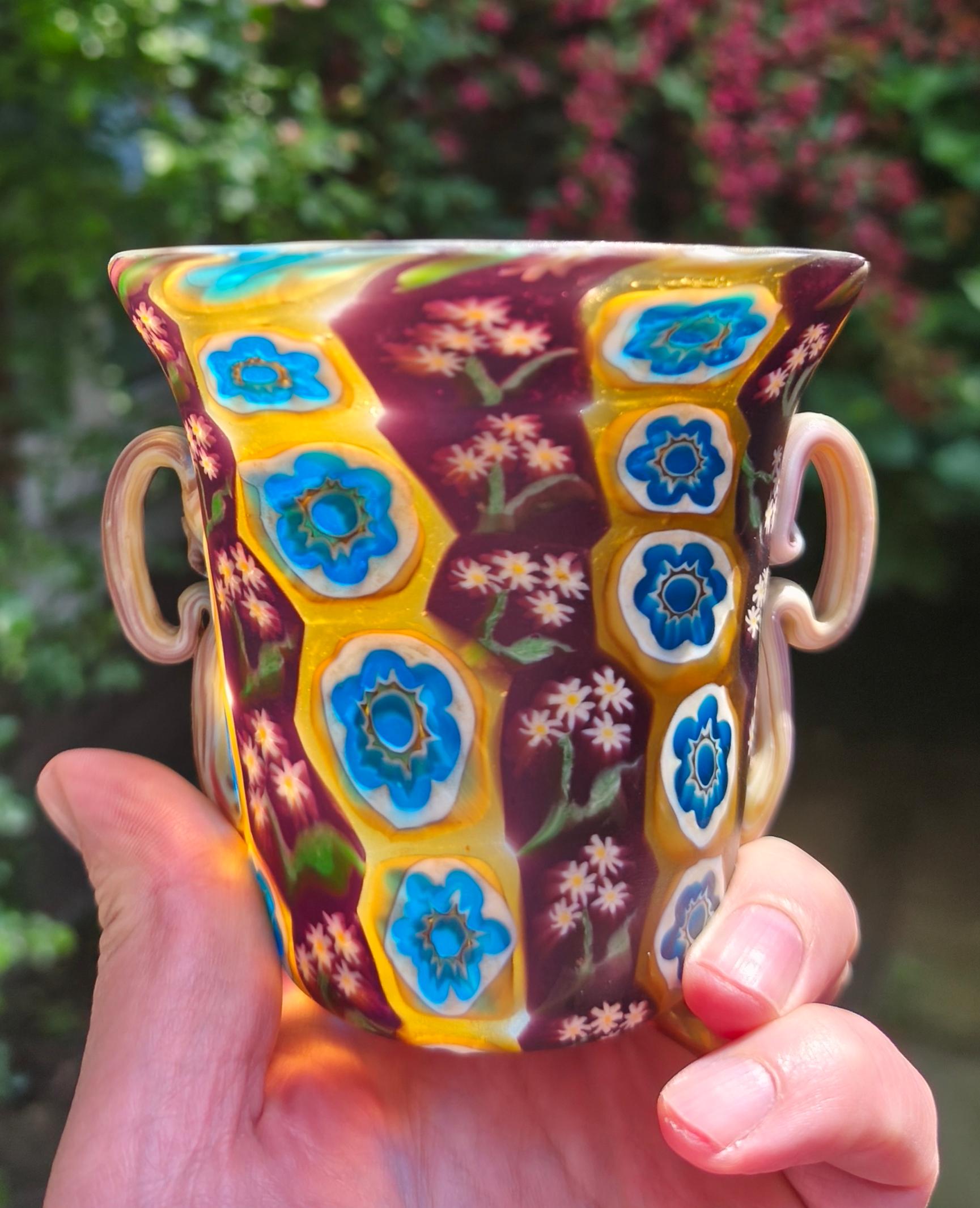 A fine millefiori murrine vase by the Toso brothers, made on the island of Murano around 1910. The lovely colored and decorated murrine were cut from glass canes, arranged on a plate, fused and then attached to the glass pipe for a little roll up.