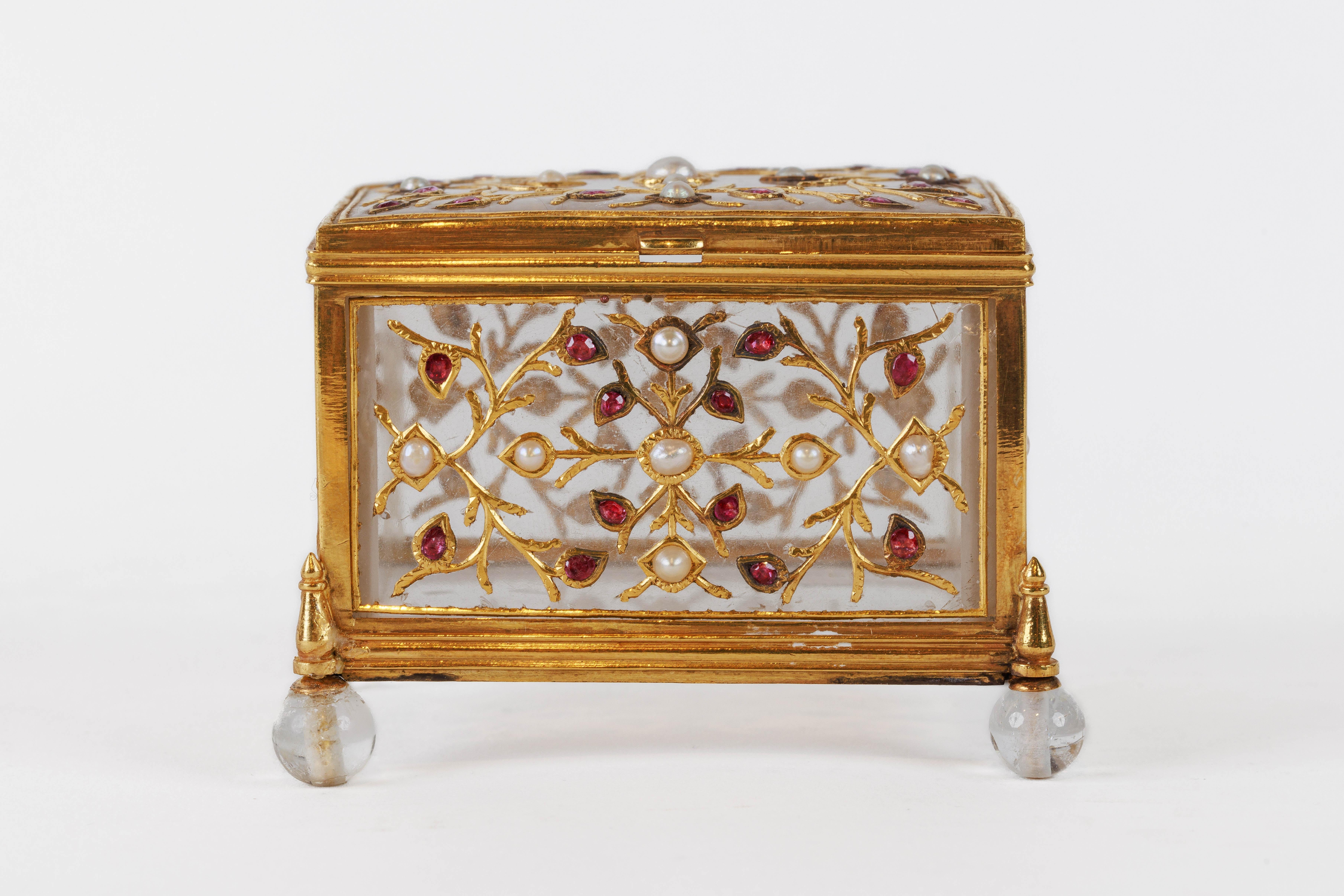 A Fine and Exquisite Mughal Gem Set Rock Crystal and Gold Box, India, 18th Century.

Finley set in 22k gold, mounted with rubies and pearls. The body carved from one piece of rock crystal, set with rubies and pearls in finely crafted gold mounts,