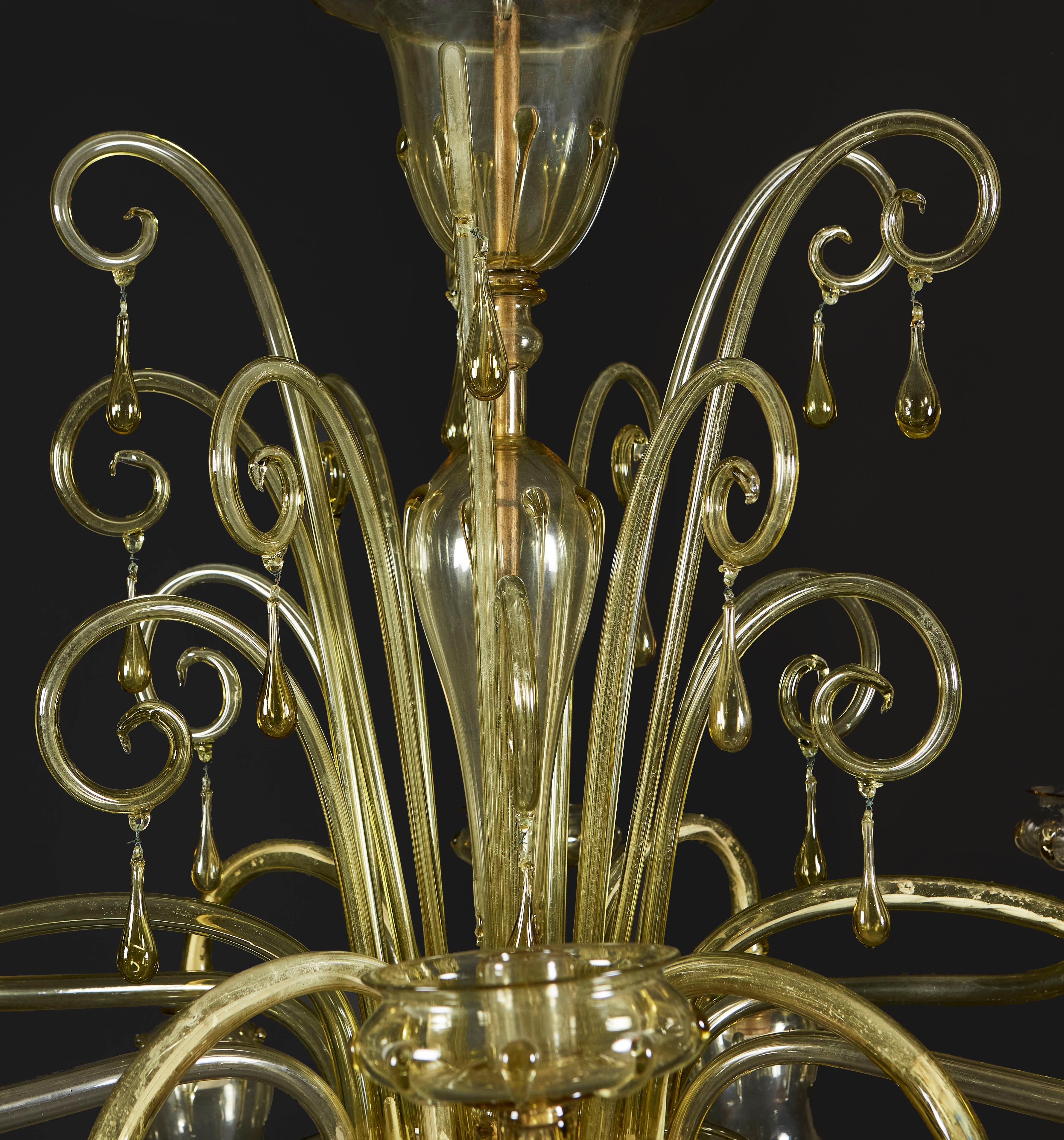 A fine green Murano glass chandelier with six candle arms with teardrop pendants beneath, and six downward arms with glass dome shades, the top with scrolling glass fronds of varying lengths encircling the central column, each with a hanging
