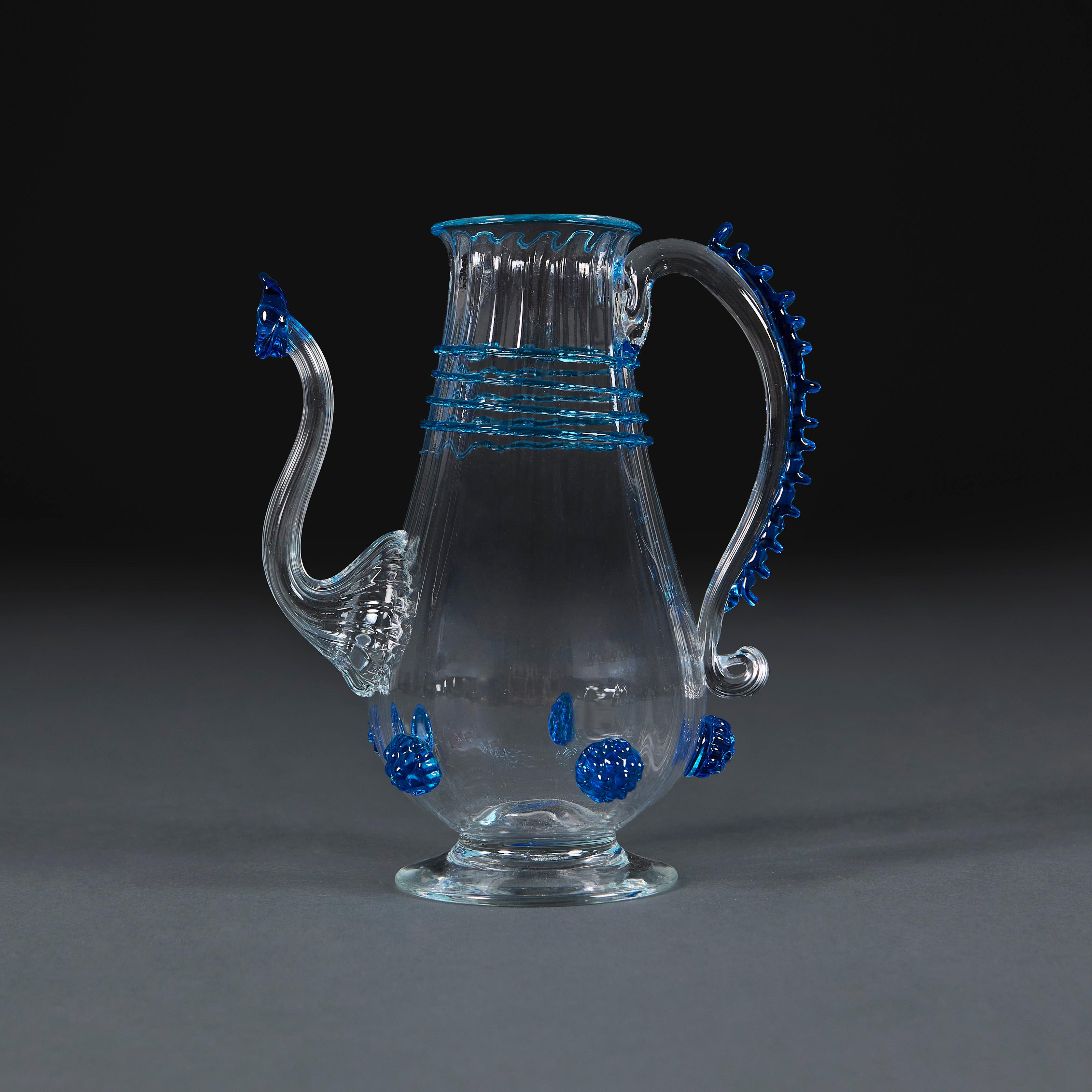 Italy, Murano, circa 1940.

A fine Murano olive oil ewer of diminutive form, decorated with stylised blue paterae and applied spiral lines to the body.

Height 17.00cm
Width 10.00cm
Depth 15.00cm