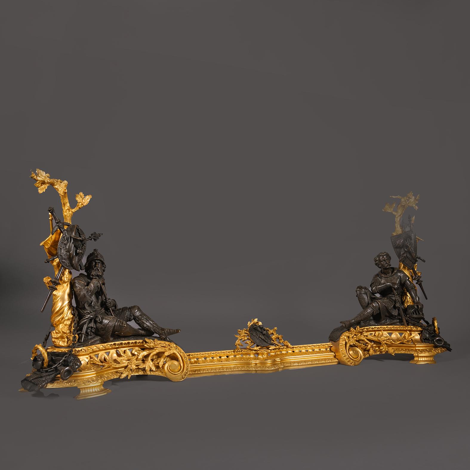 A Fine Napoleon III Period Gilt and Patinated Bronze Figural Chenet and Fender. 

Finely cast and chiselled in gilt and patinated bronze this impressive fender is in the form of scrolling foliate chenets with seated soldiers reclining against trees,