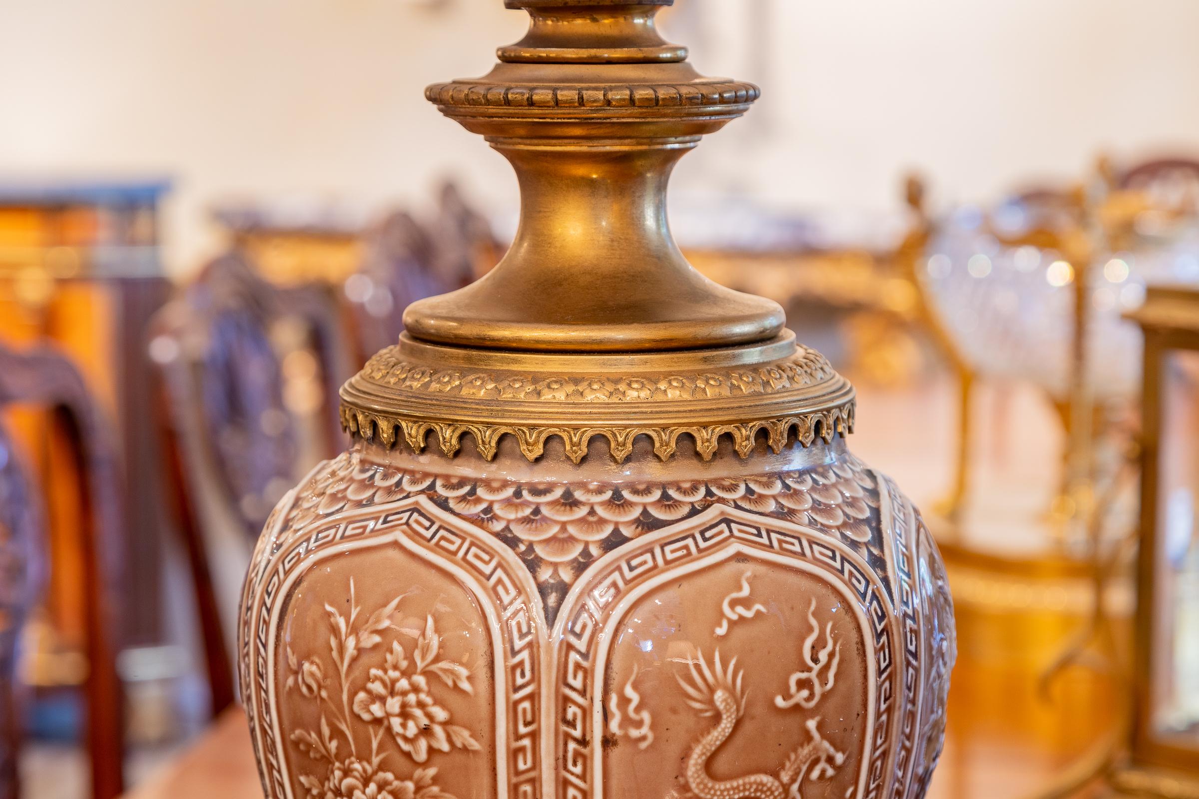 A fine pair of 19th century French Orientalist Chinoiserie designed porcelain urns with fine gilt bronze mounts. Glazed urn with Oriental decoration.