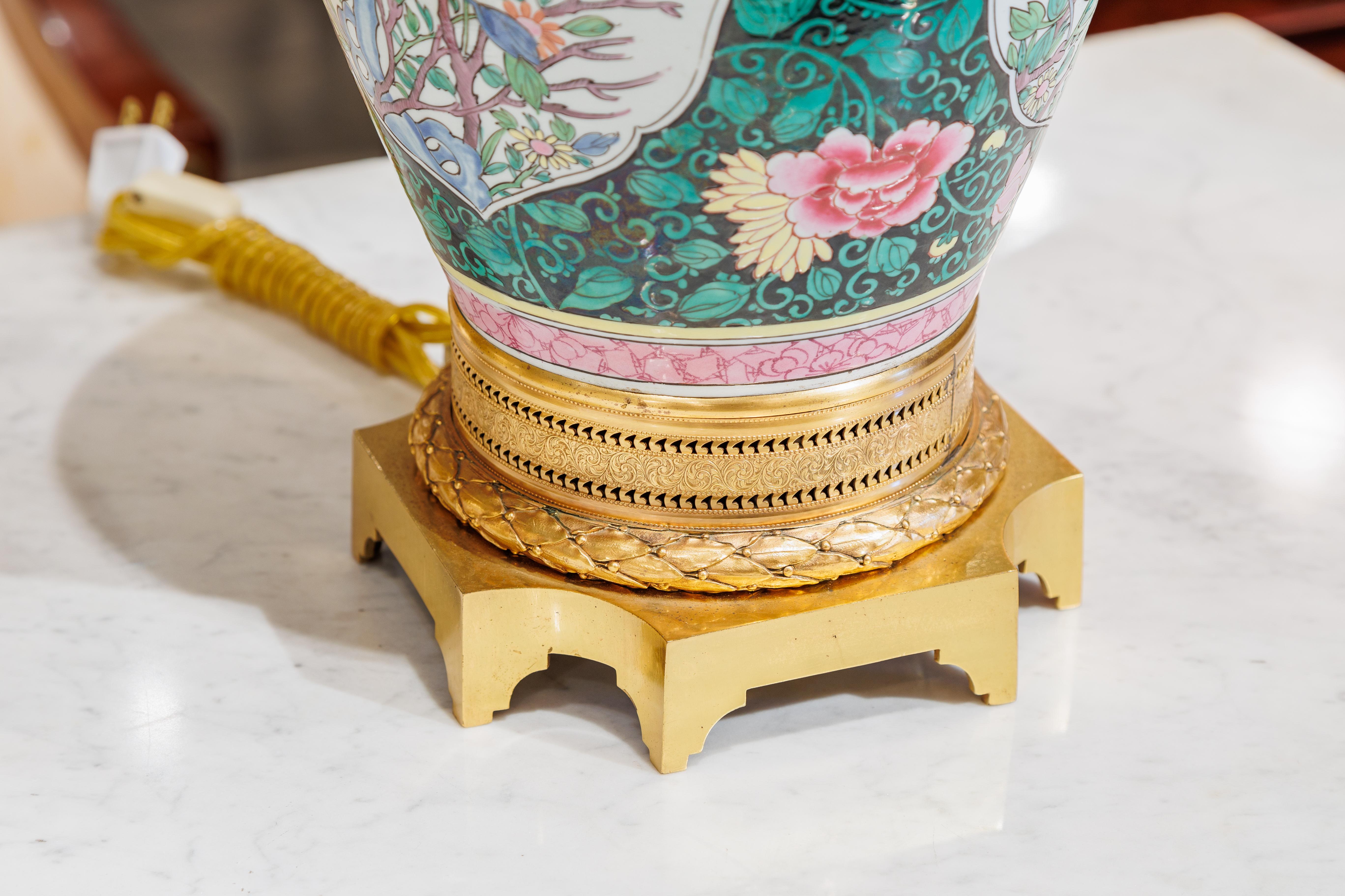 A fine pair of 19th century Famille Verte porcelain and gilt bronze vase lamps.