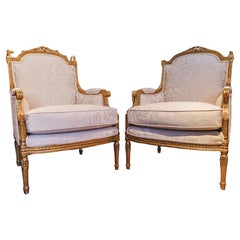 A fine pair of 19th c French Louis XVI gilt carved bergeres.