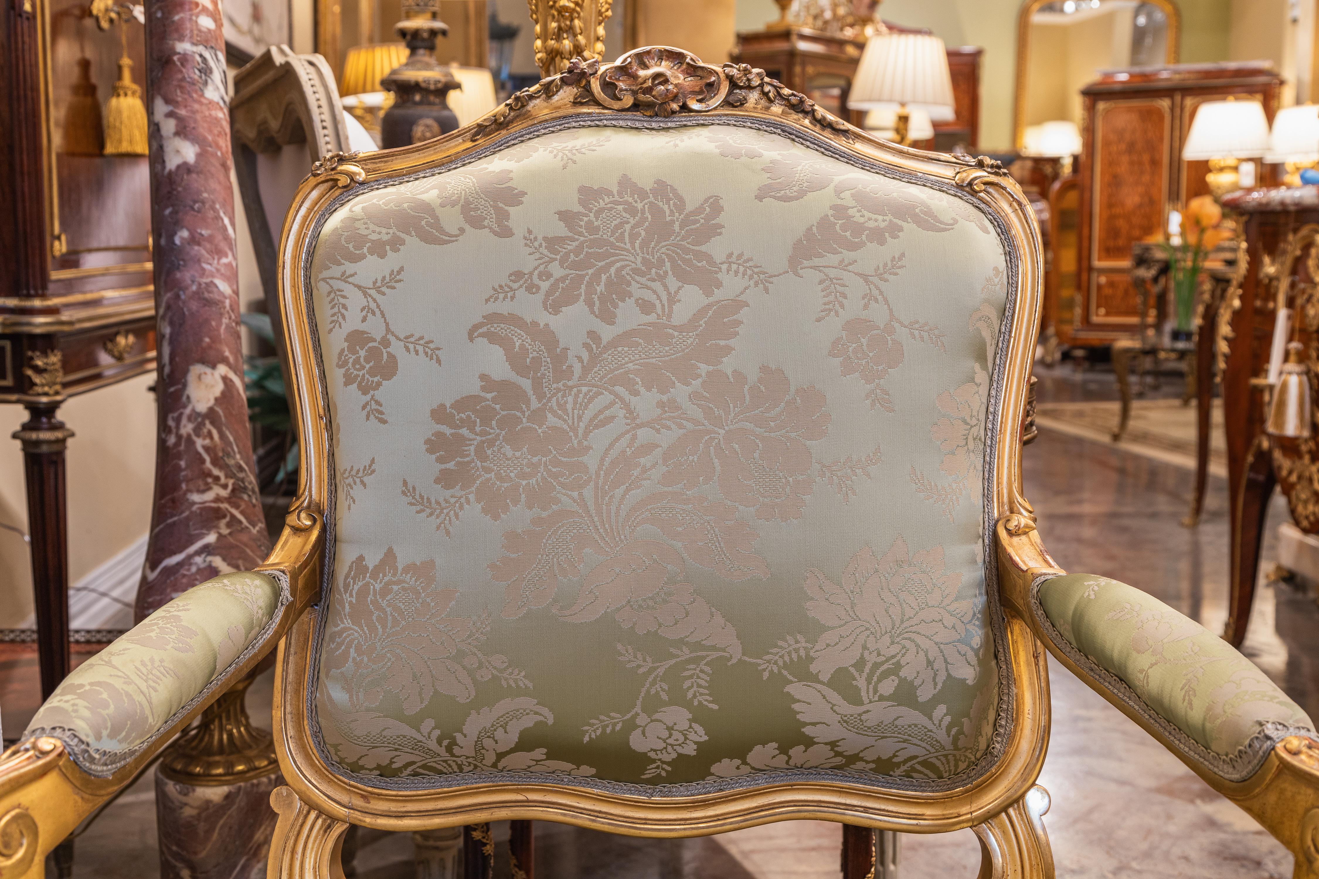 A fine pair of 19th c Louis XV water gilt fauteuils . Fine carving with a silk  In Good Condition For Sale In Dallas, TX