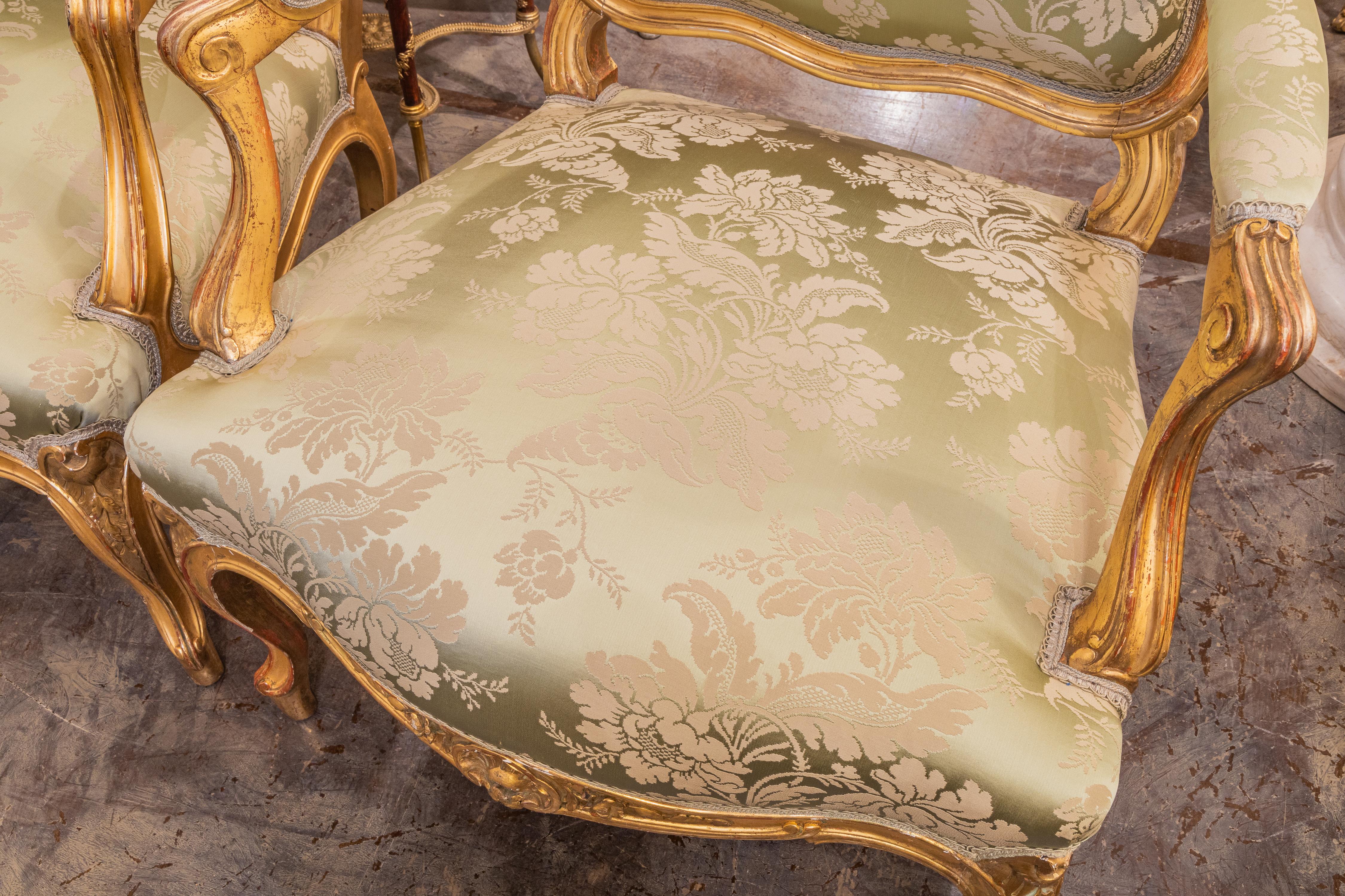 19th Century A fine pair of 19th c Louis XV water gilt fauteuils . Fine carving with a silk  For Sale