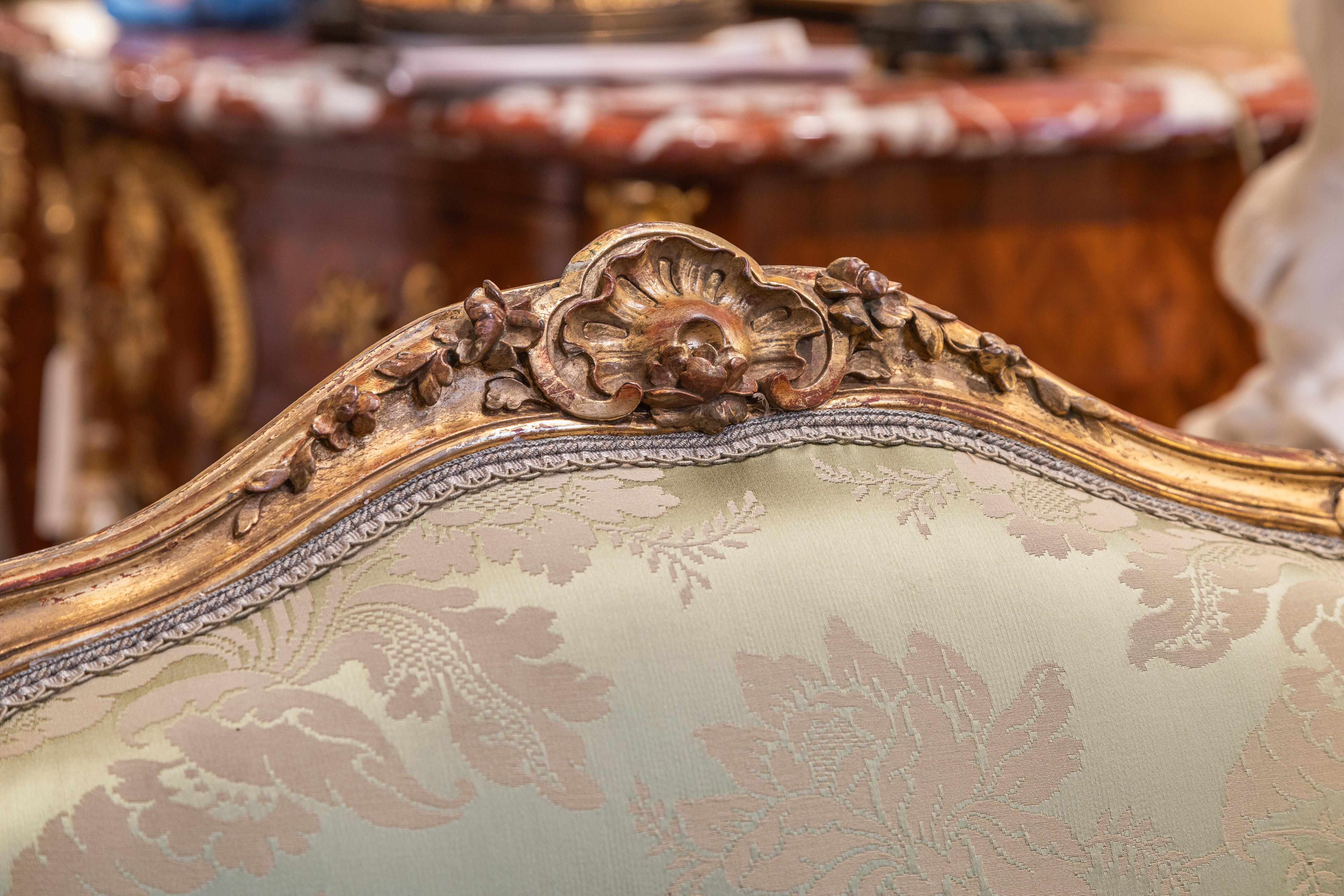 Giltwood A fine pair of 19th c Louis XV water gilt fauteuils . Fine carving with a silk  For Sale
