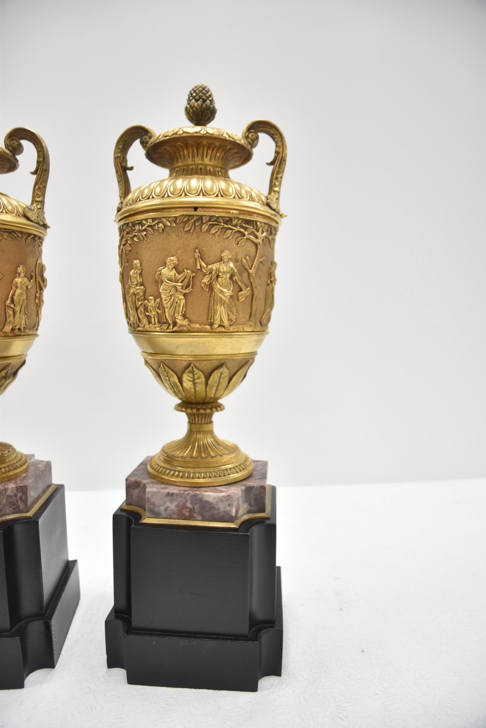 A fine pair of 19th century French gilt bronze urns with classical figures on marble bases. Attributed to Barbedienne.
