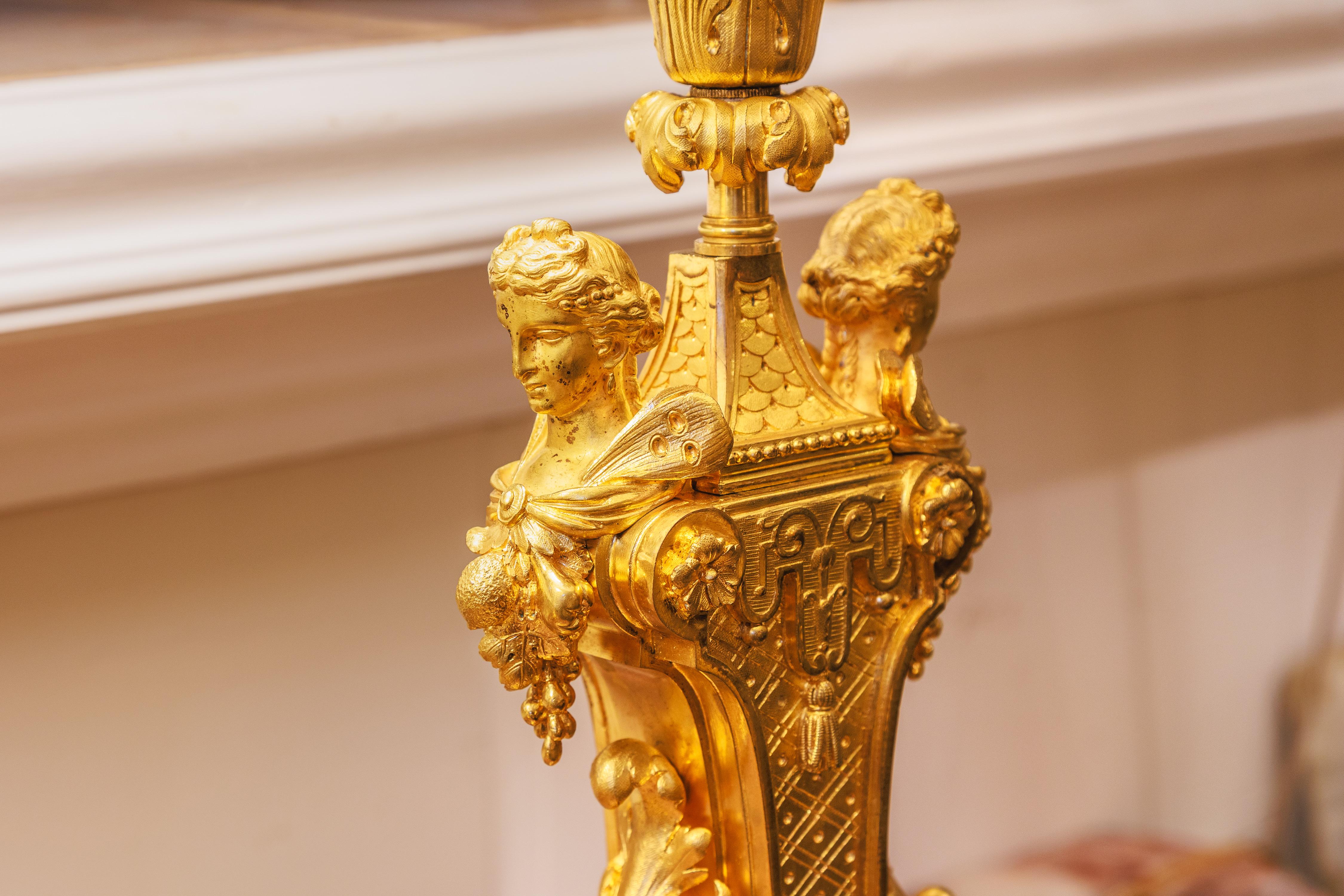 A fine pair of 19th century French Louis Philippe gilt bronze finely detailed cherub lamps . Winged fairies on either side 