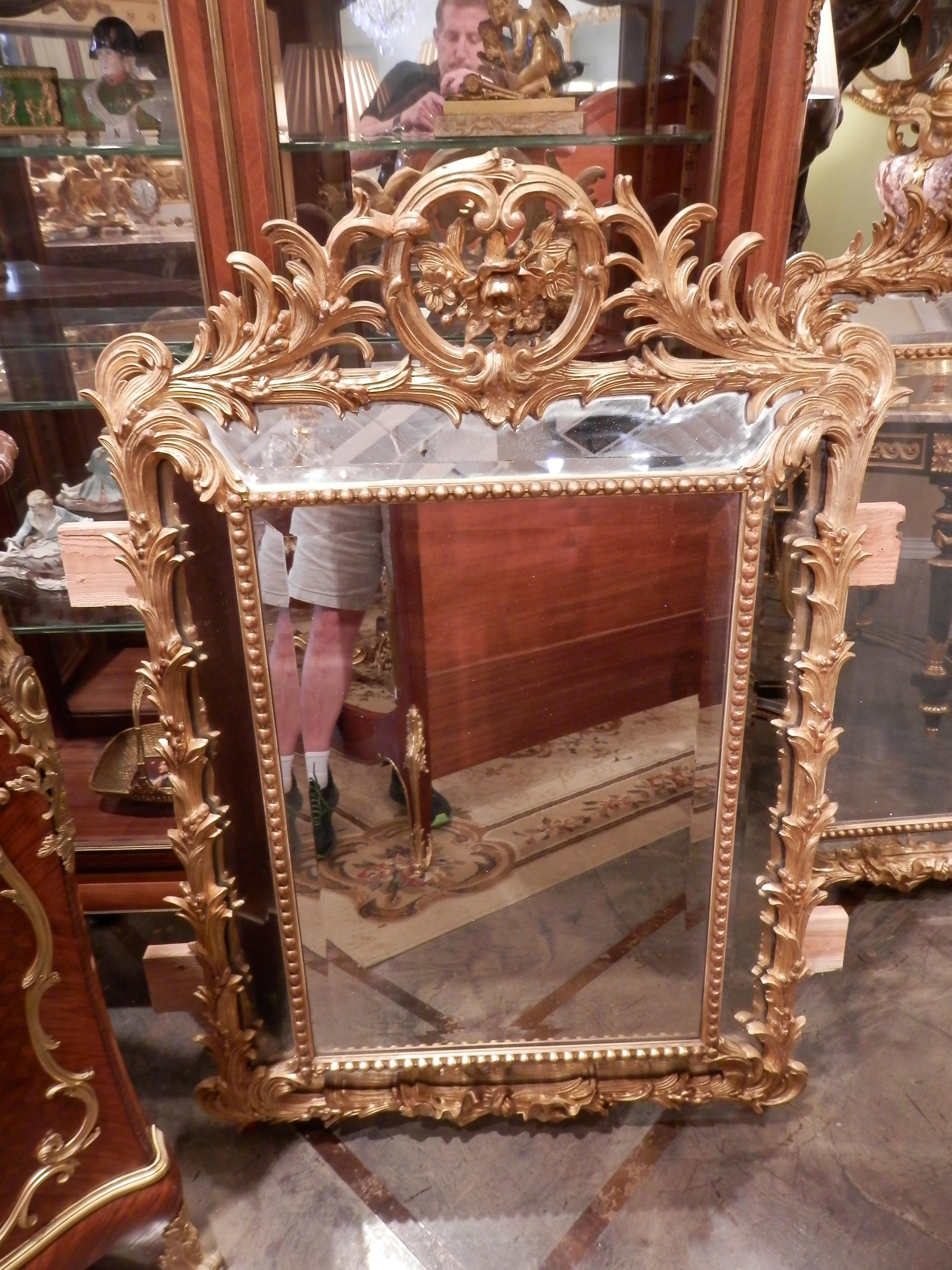 A beautiful pair of 19th century finely carved French gilt carved Louis XV mirrors. Double beveled with fine carved flowers and acanthus leaf design. Beaded trim. All original.