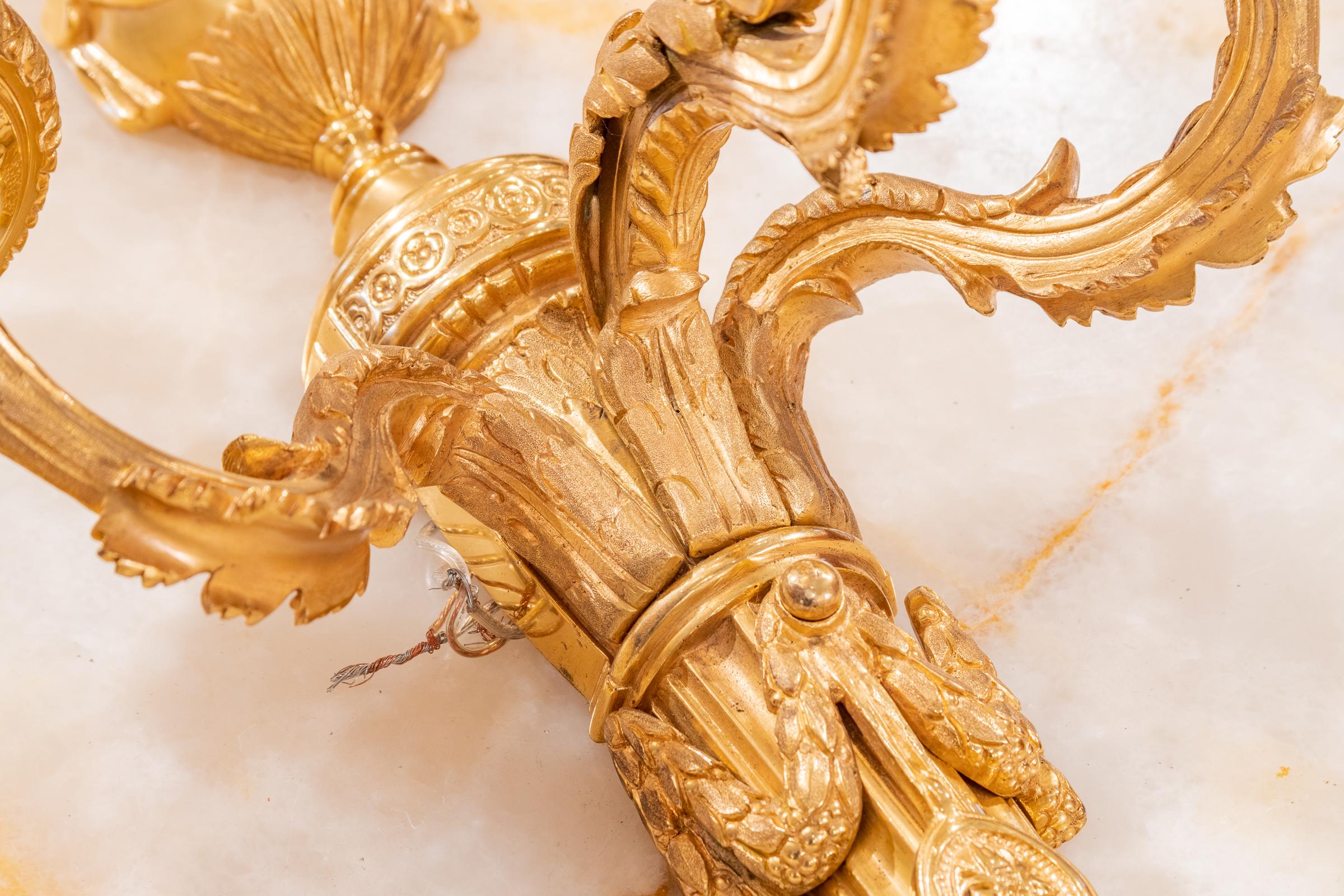 A fine and beautiful pair of 19th century French Louis XVI gilt bronze sconces.