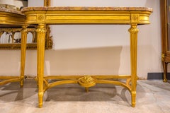 A fine pair of 19th century French Louis XVI gilt carved marble top consoles
