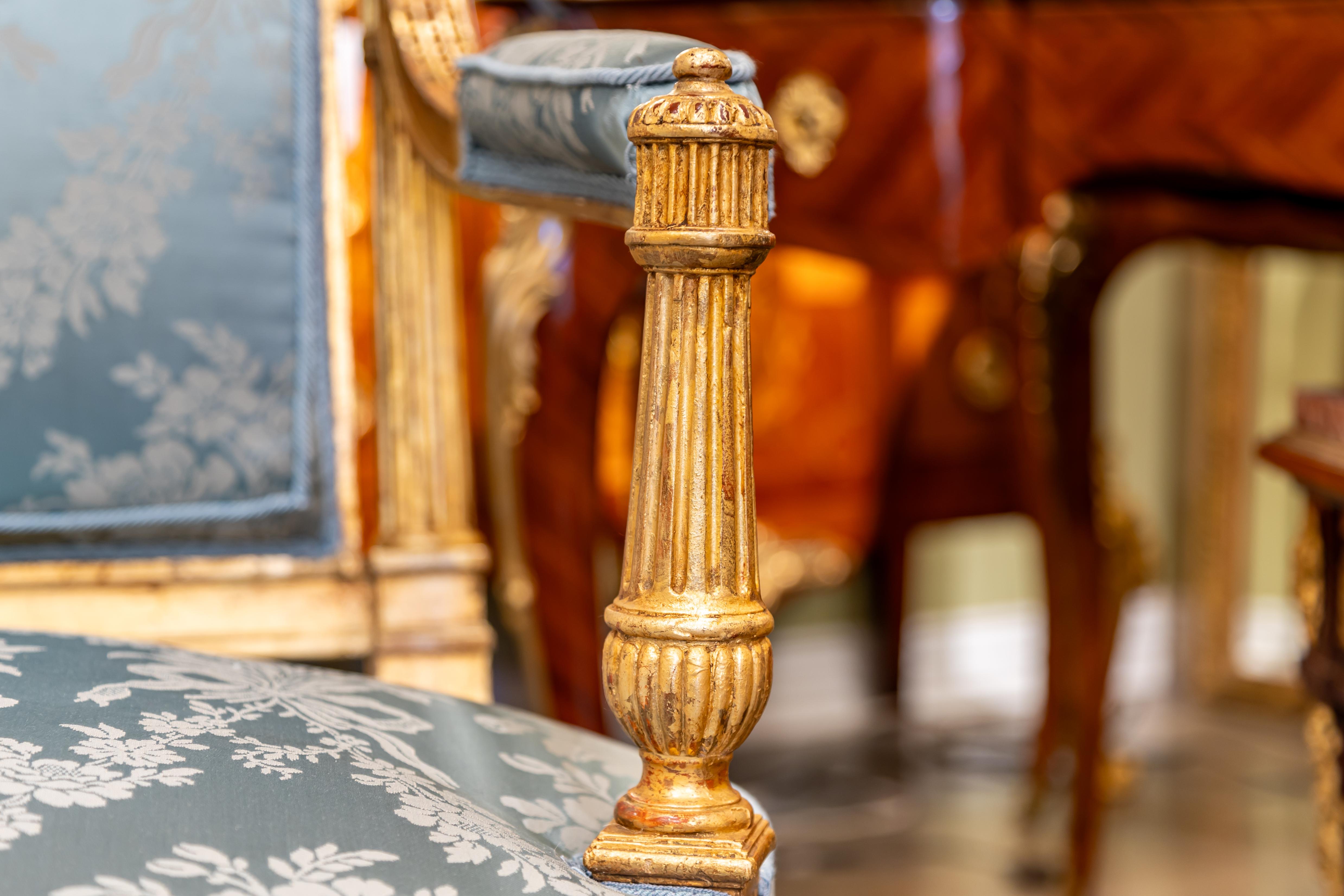 Hand-Carved A fine pair of 19th century French Louis XVI hand carved and gilded armchairs.  For Sale
