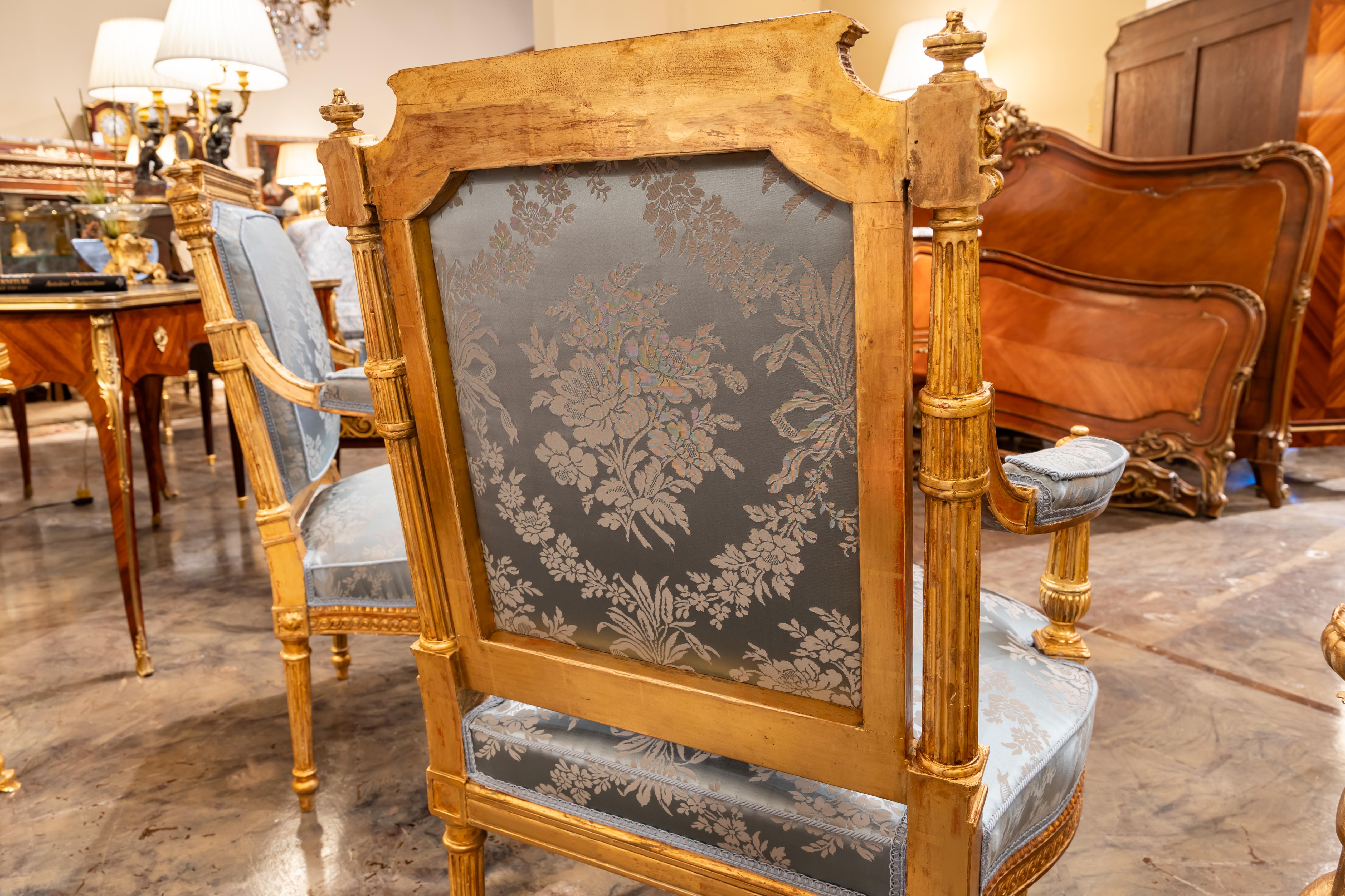 A fine pair of 19th century French Louis XVI hand carved and gilded armchairs.  For Sale 1