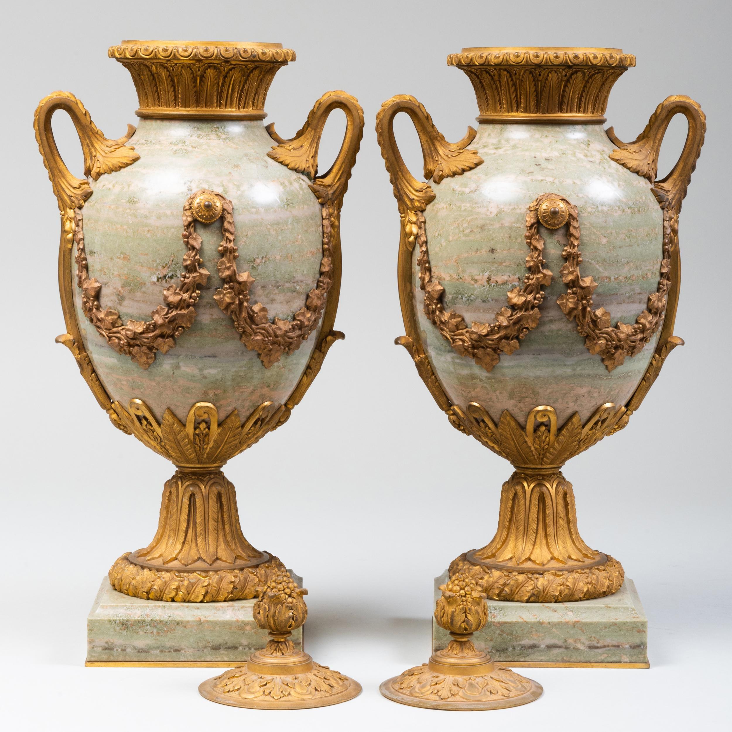 A fine pair of pale green 19th century marble and gilt bronze lidded urns. Fine quality.