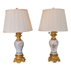 A fine pair of 19th century French porcelain and gilt bronze oil lamps .