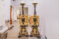 A fine pair of 19th century Italian painted black and gilt carved torchieres
