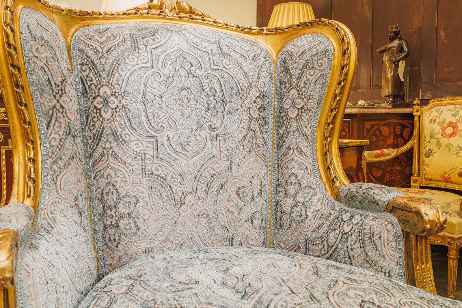 A fine pair of 19th century French Louis XVI carved and water gilt wingchairs . 