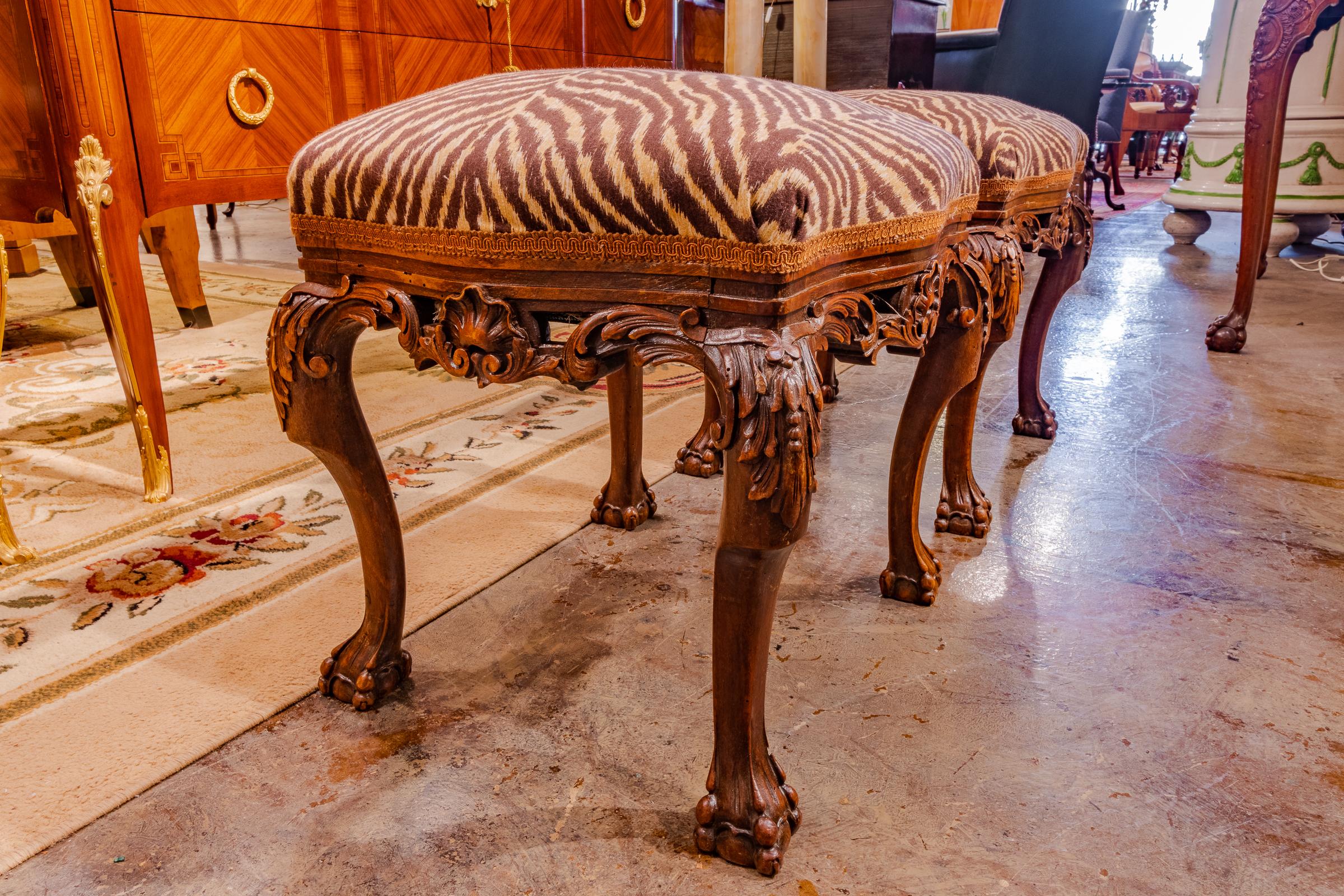 A fine pair of hand carved 19th century French walnut stools with a animal print fabric in great condition.