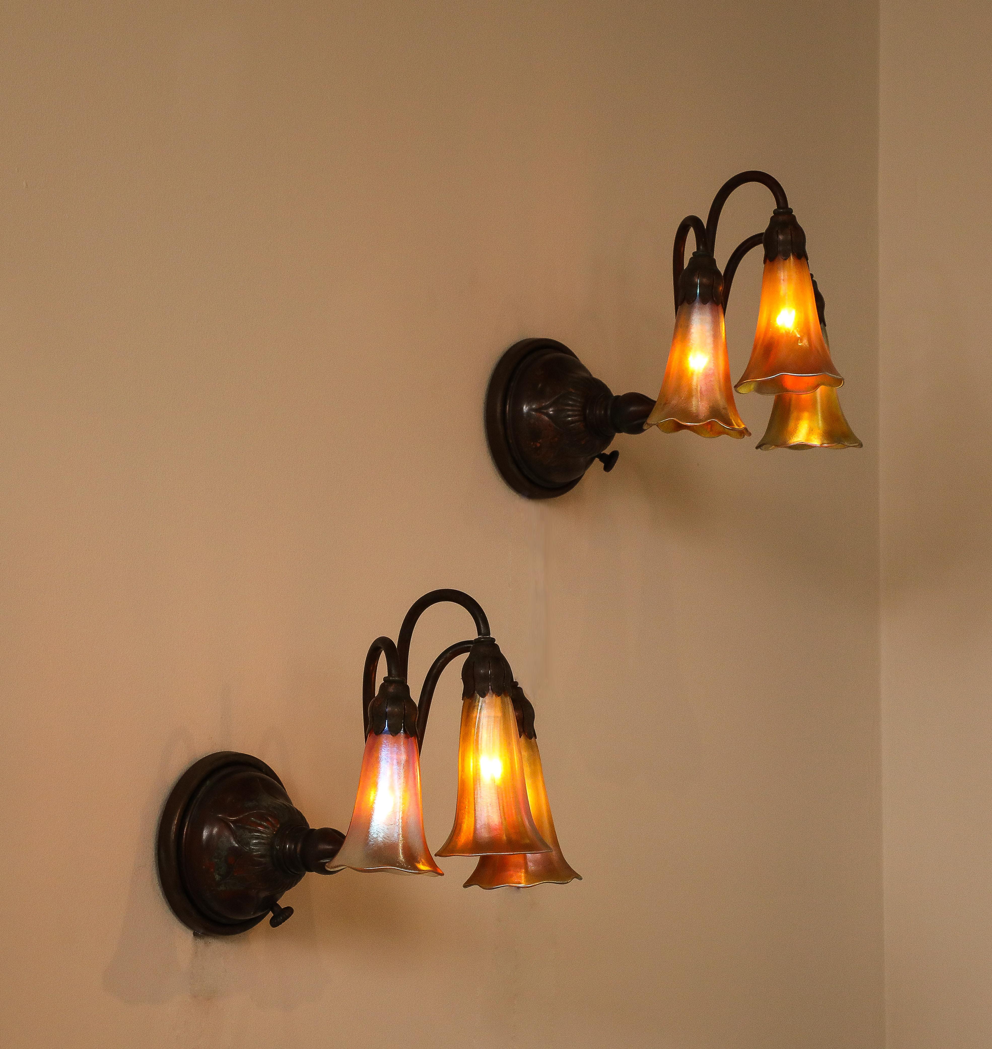 A Fine Pair of 3 Light Wall Sconces, by Tiffany Studios In Good Condition For Sale In New York, NY