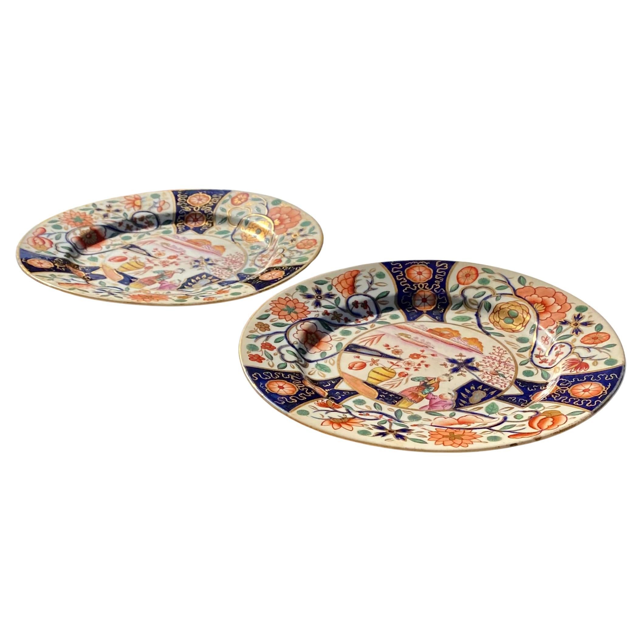 A fine pair of antique Chamberlains Worcester cabinet plates having a pleasing Asian design of figures in a garden and gorgeous Imari colors, circa 1810.
 
In 1783, Robert Chamberlain (c.1736–98), head of the decorating department for Dr John Wall