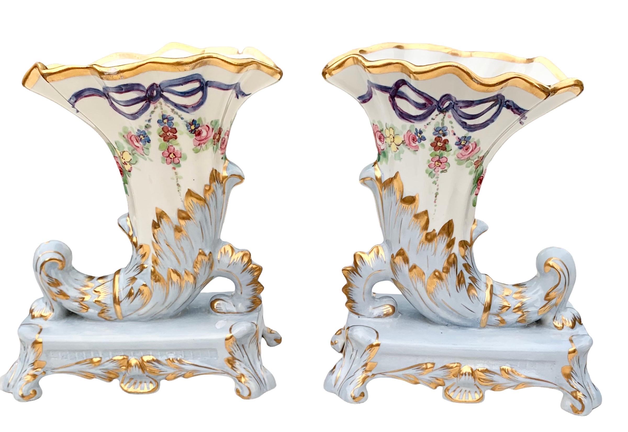 A fine pair of antique French Belle Epoch Limoges porcelain cornucopia vases, C. 1890’s. Created with the most beautiful shades of heavenly blue and gold accents. 

These vases are the finest hand painted porcelain and represent the absolute