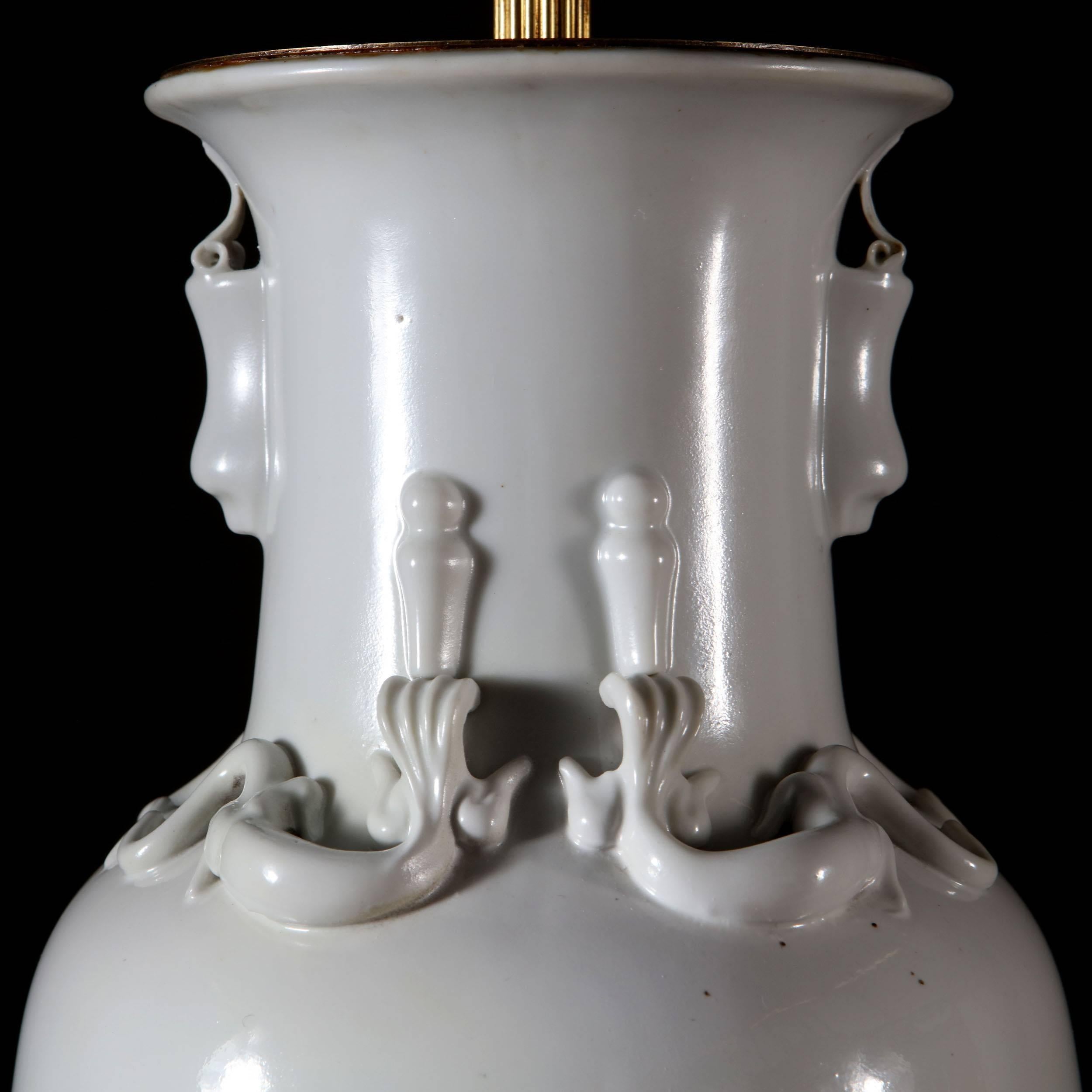 A fine pair of large Blanc de Chine vases, now converted as lamps, with lizards to the neck.