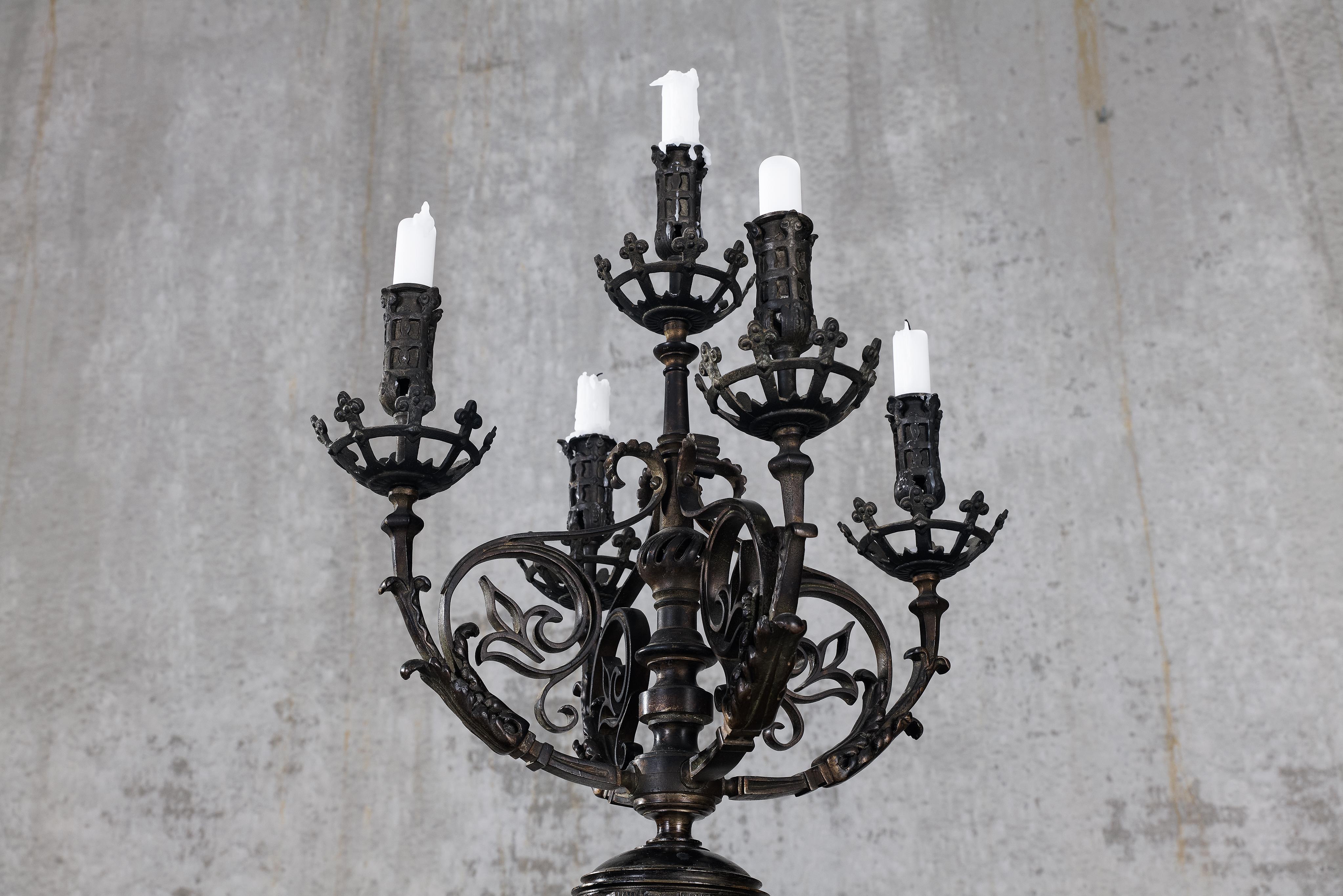 This impressive pair of five-light candelabra stems from the late nineteenth century. The ornate design, possibly French, exhibits a great deal of detailed craftsmanship. The five arms are adorned with foliage, displaying both ornamental acanthus