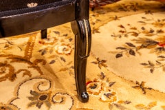 A fine pair of Charles X  ebonized and gilt bronze mounted fauteuils