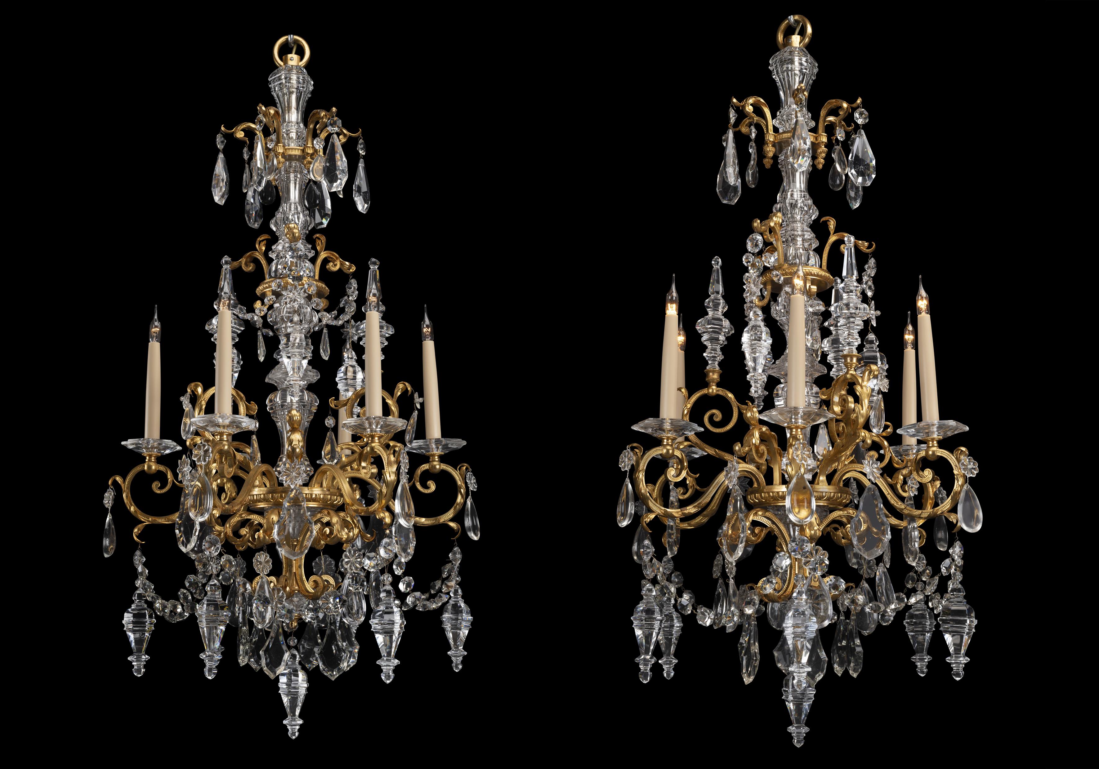 A fine pair of cut-glass and gilt-bronze six-light chandeliers. 

French, circa 1890. 

Each chandelier has a central moulded glass baluster column issuing six leaf ornamented scrolling gilt-bronze branches. The chandeliers are adorned with