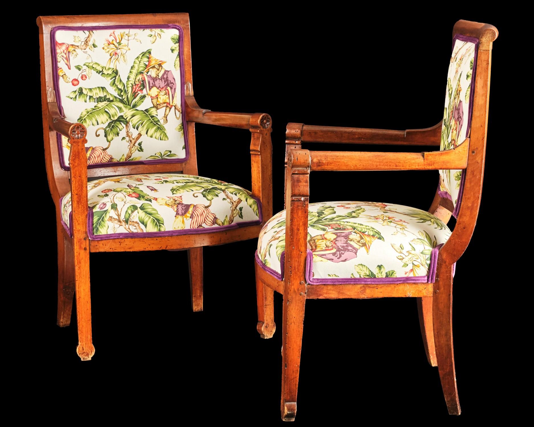Both upholstered walnut frames of pegged construction, showing rolled crest-rails over turned armrests terminating to rounded grips decorated with foliate carved roundels, raised overall on shaped stile supports. 