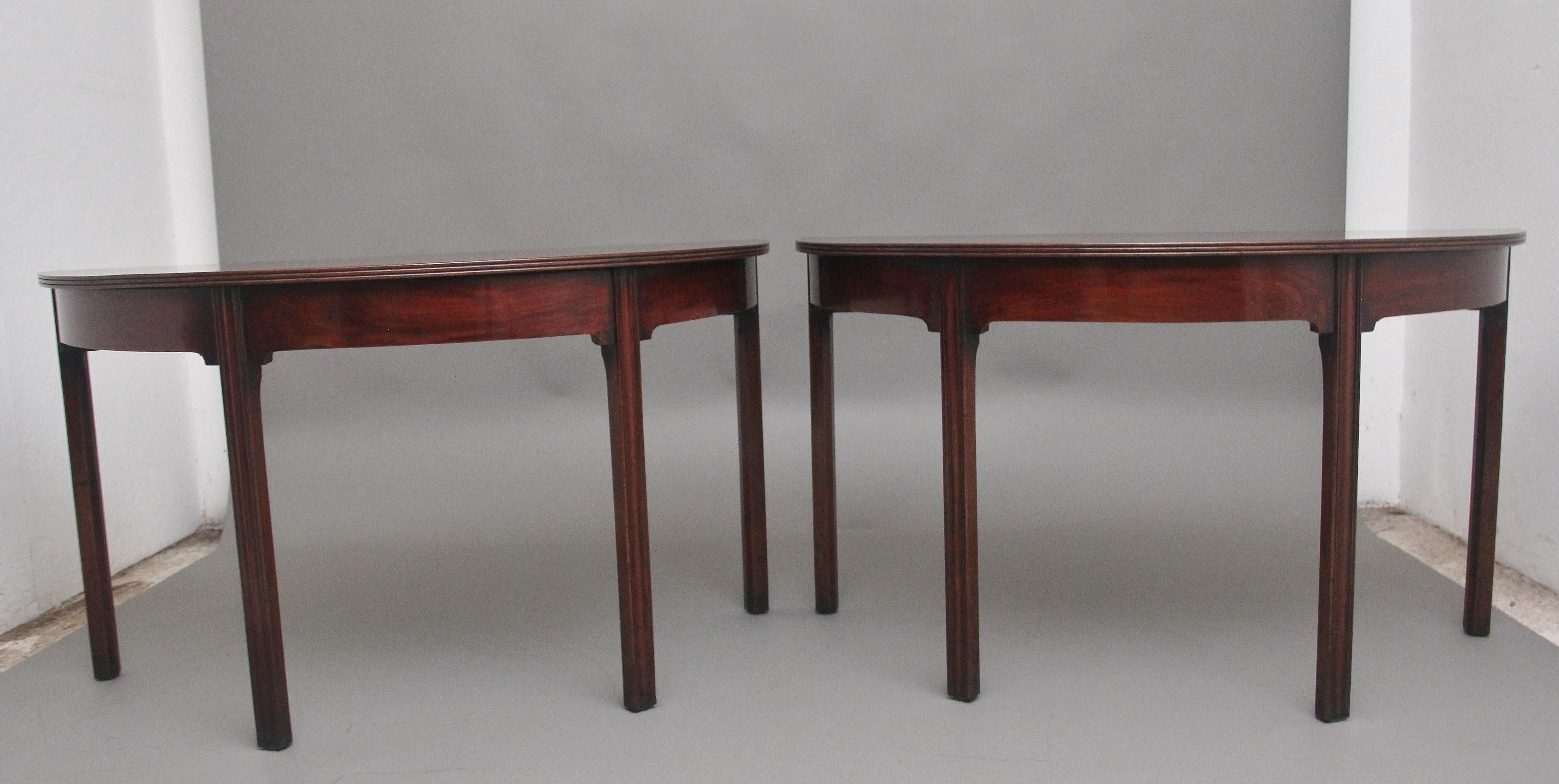 A fine pair of early 19th Century mahogany demi-lune console tables, having lovely figured tops with a reeded edge above a shaped frieze, supported on square legs, lovely colour and in excellent condition.  Circa 1810.
 