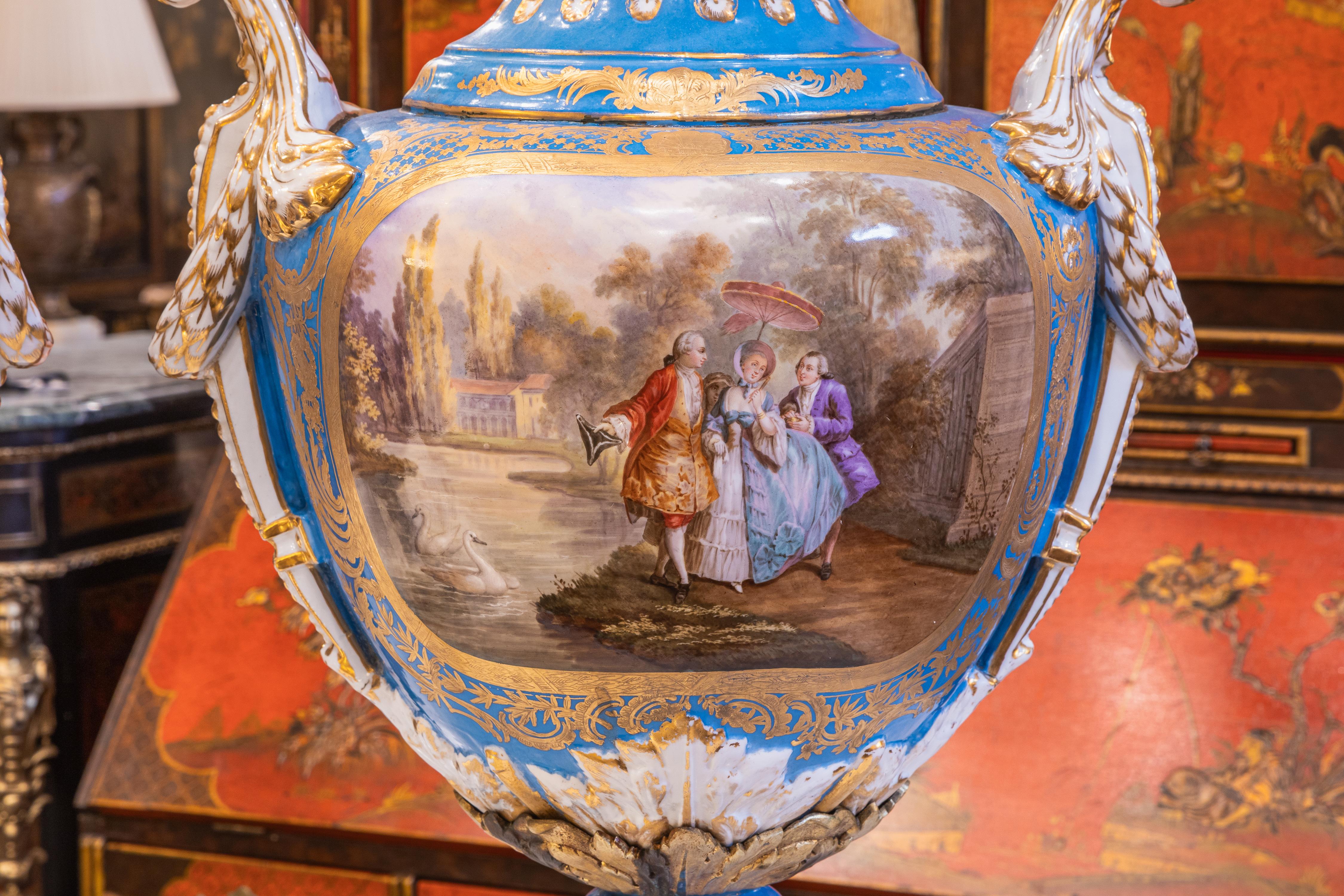 A very fine pair of late 19th century to early 20th century French Sevre's style palatial porcelain vases. Hand painted and signed scenes of Versailles. 
