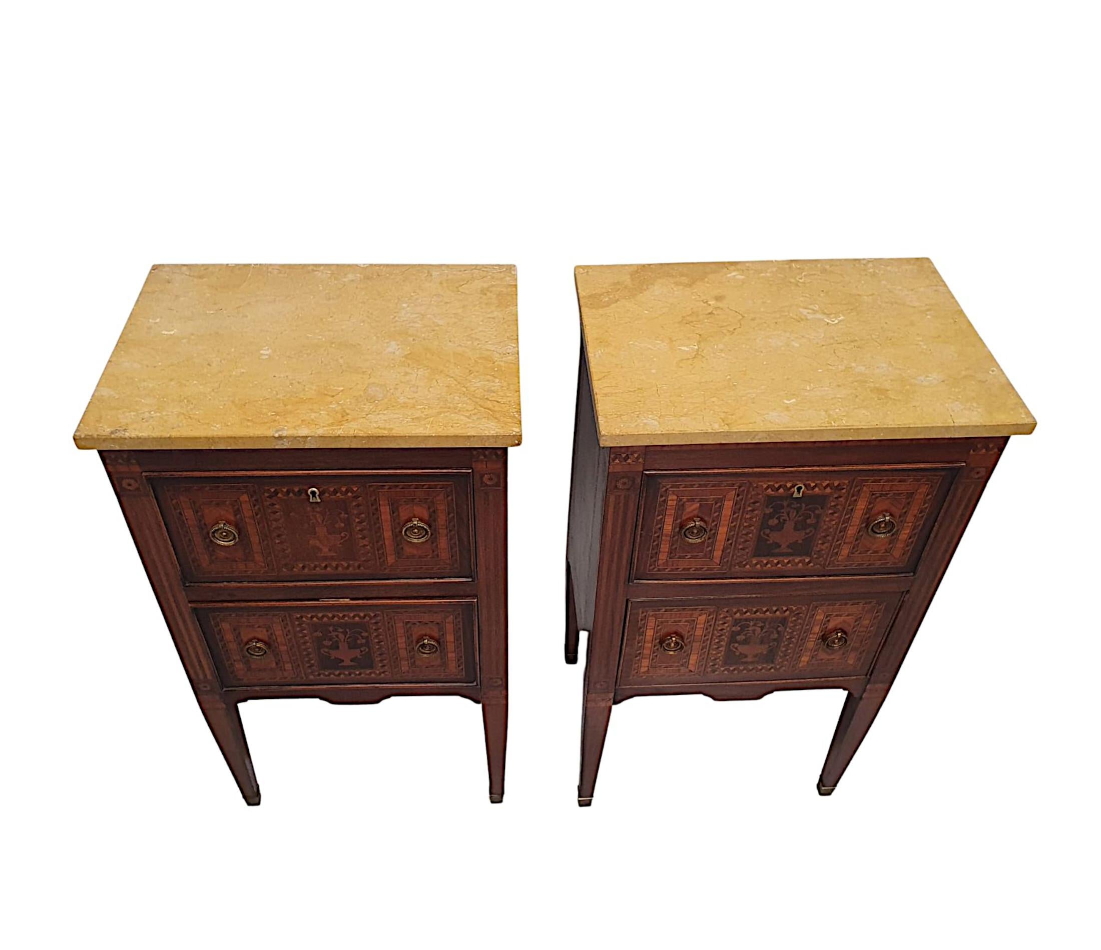 A fine pair of early 20th Century marble top bedside chests of drawers, of fabulous quality, finely carved with rich patination and grain, cross banded throughout and with highly inlaid marquetry panels.  The gorgeous, moulded Sienna marble top of