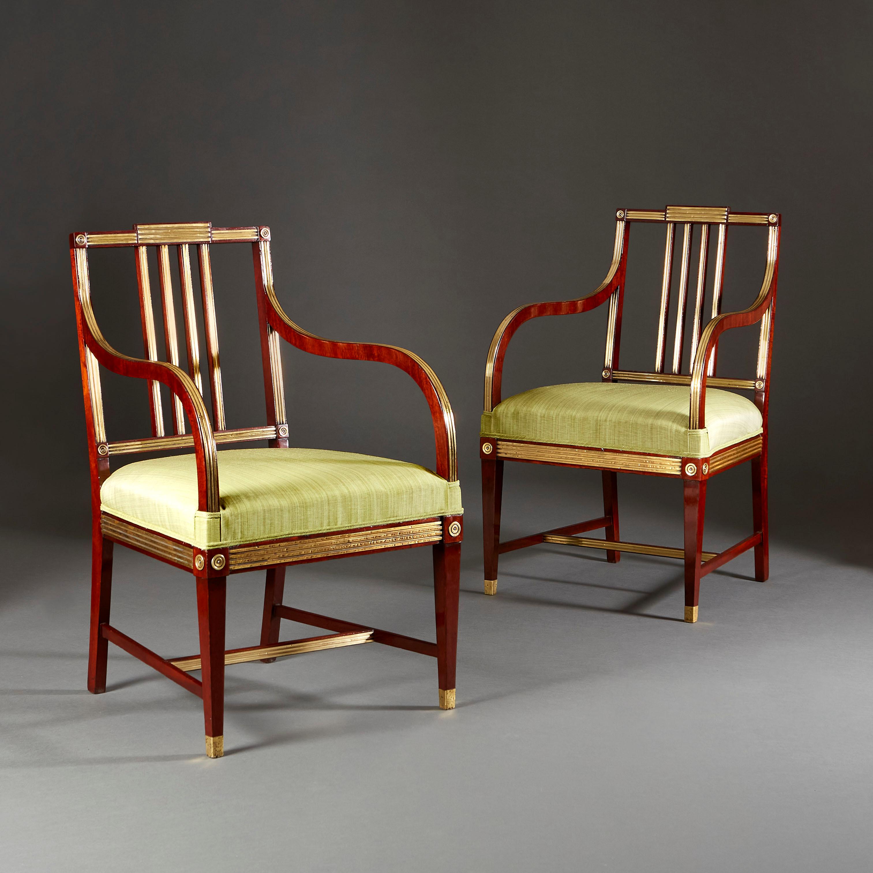 A fine pair of early nineteenth century Russian open armchairs. The frames with impressed brass inlay, the backs flat with circular paterae, all supported on four legs with topie feet.