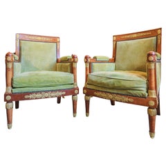 A fine pair of French 19thc Empire walnut and gilt bronze mounted large bergeres