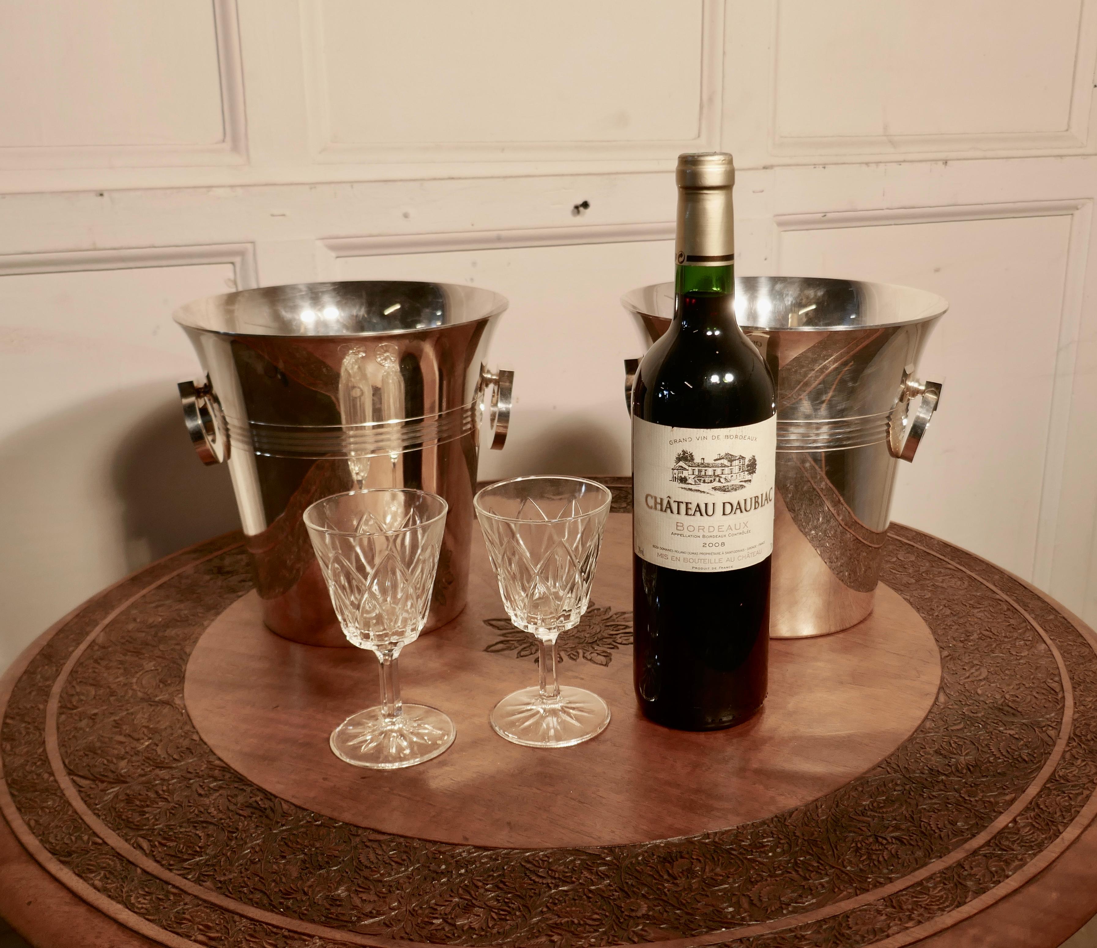 A fine pair of french Art Deco style wine coolers, champaign ice buckets

A very attractive pair of vintage ice buckets in French silver plate, they splay out at the top, have ring hanldes and a decorative reeding and around
The coolers have not